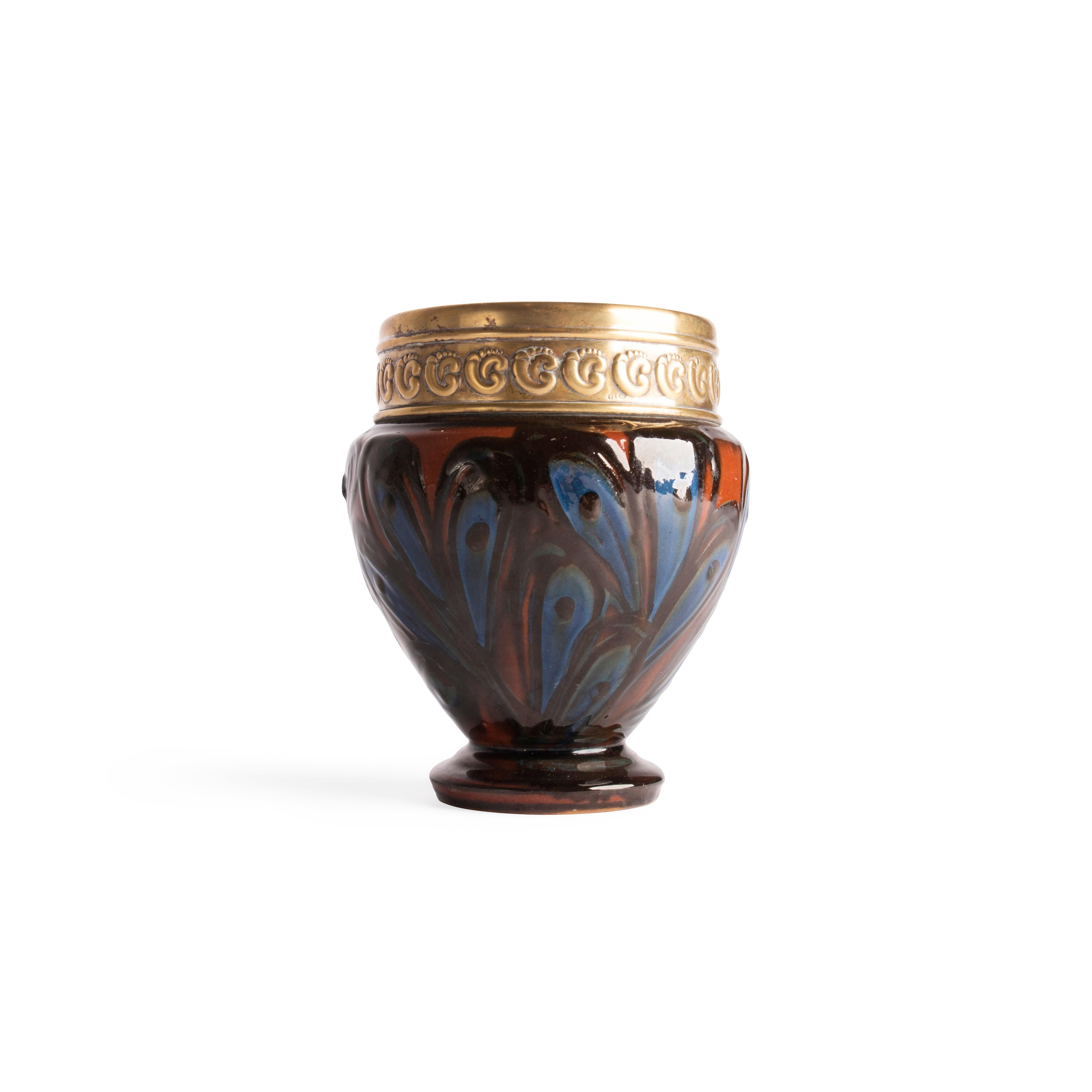 This important vase with a gold plated silverplate mount was designed by Thorvald Bindesbøll (1846-1908) and executed by Herman A. Kähler, Denmark, early 20th century.

The neck has repoussé ornaments in the Scandinavian arts and crafts style