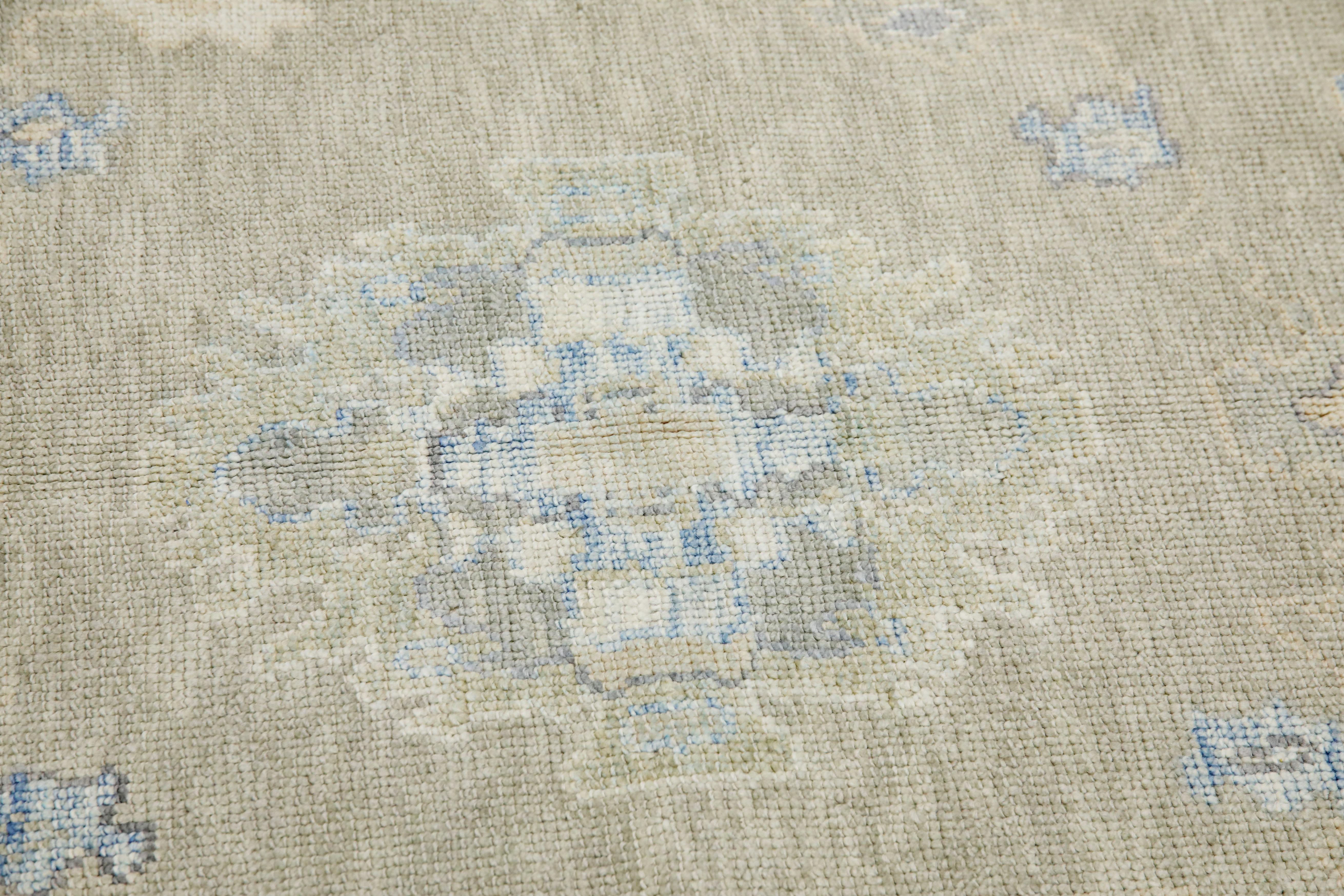 This modern Turkish Oushak rug is a stunning piece of art that has been handwoven using traditional techniques by skilled artisans. The rug features intricate patterns and a soft color palette that is achieved through the use of natural vegetable