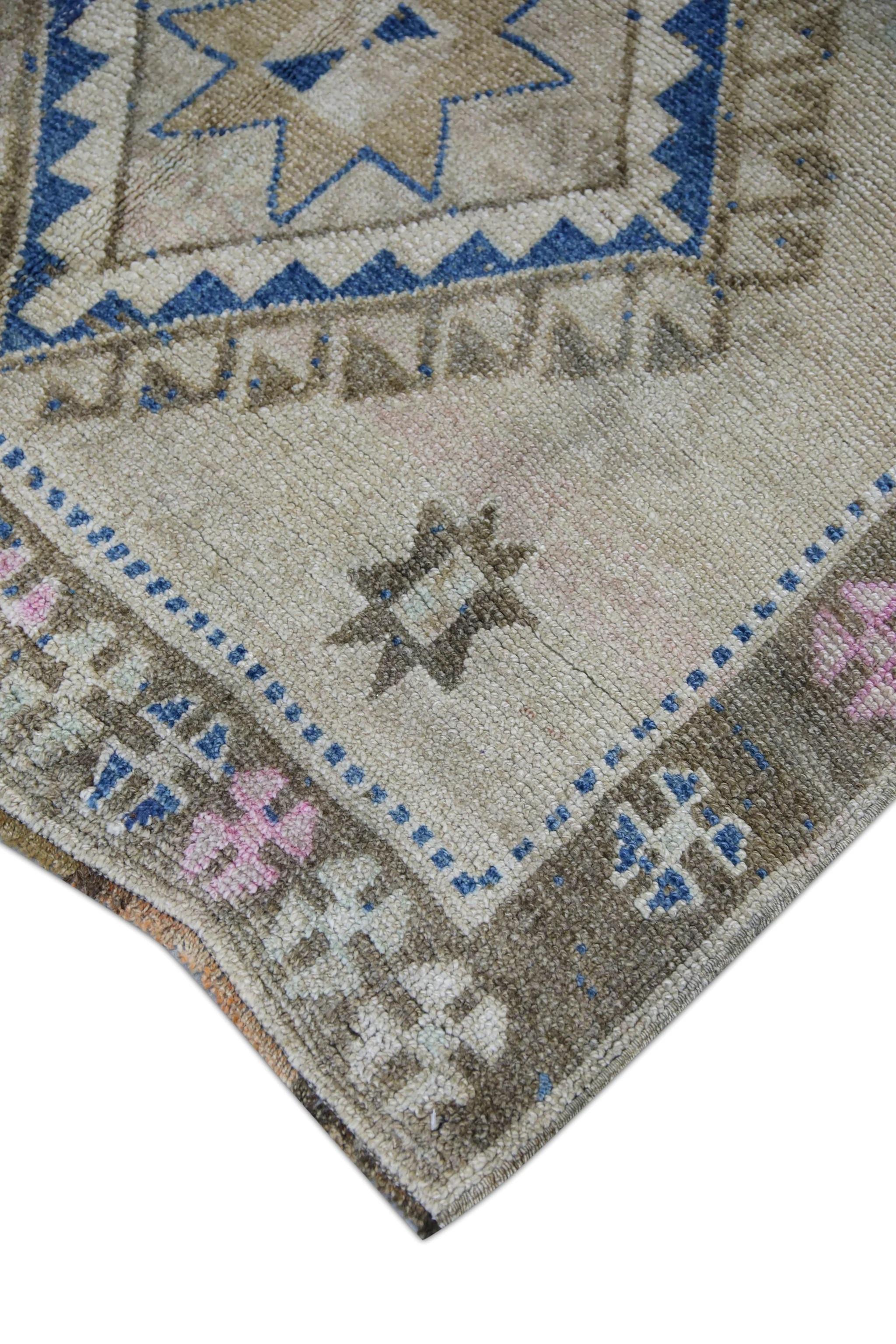 This exquisite vintage Turkish Oushak rug is a stunning example of traditional craftsmanship and timeless beauty. Hand-knotted from premium wool fibers, this rug features intricate patterns and vivid colors that are all naturally derived from