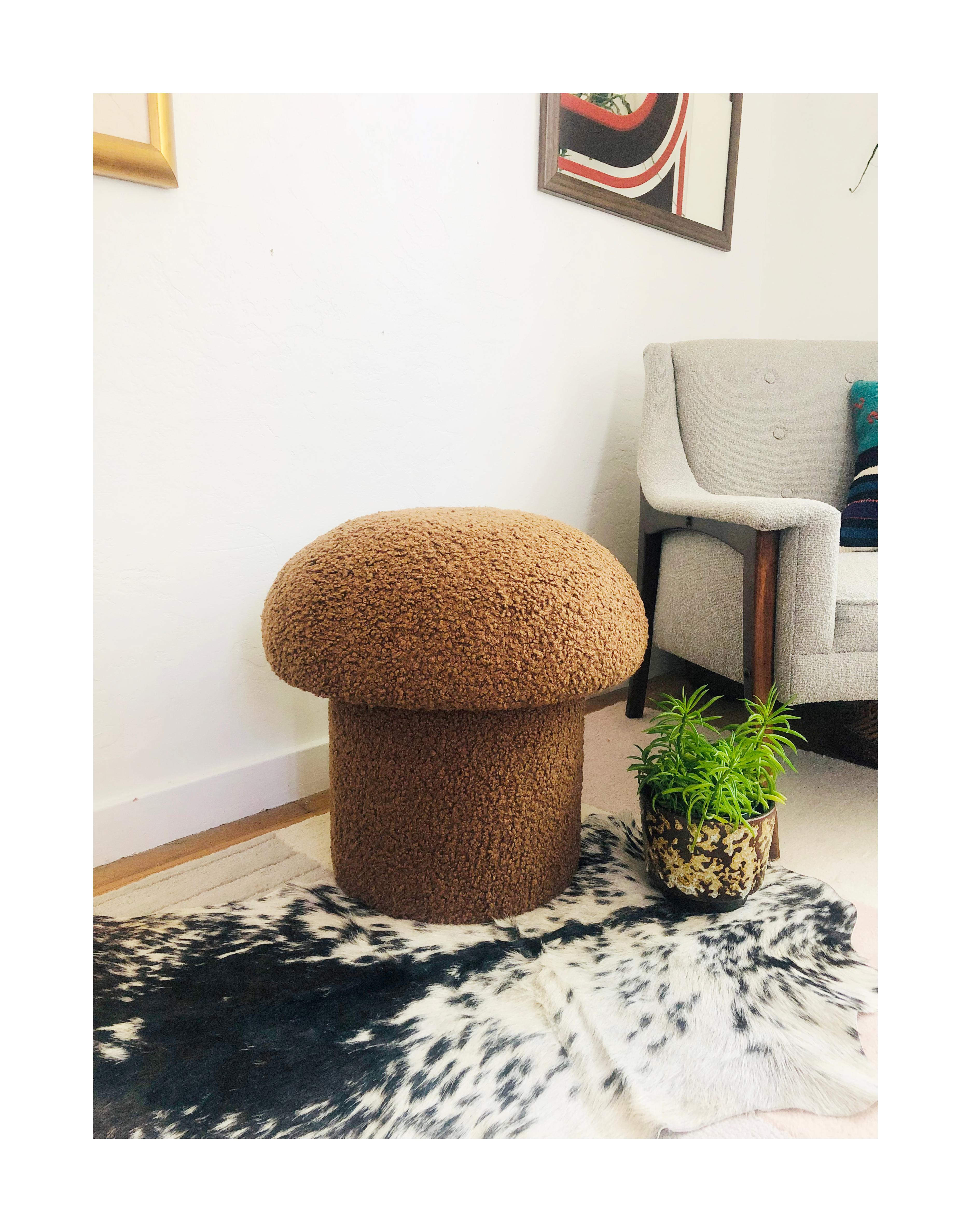 A handmade mushroom shaped ottoman, upholstered in a chestnut brown colored curly boucle fabric. Perfect for using as a footstool or extra occasional seating. A comfortable cushioned seat and sculptural accent piece.
 
