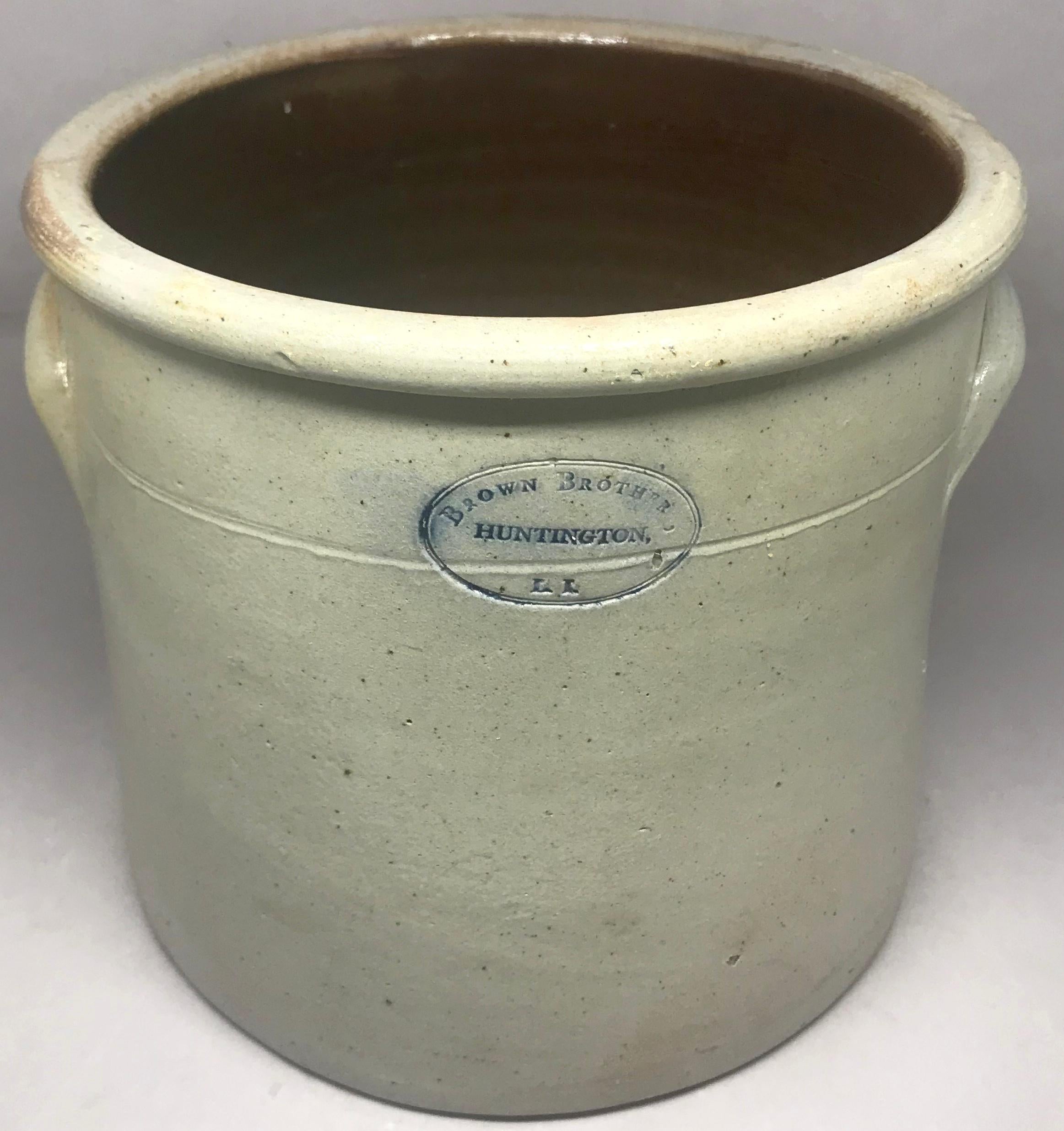 Brown Bros. stoneware crock. Antique crock in a soft putty colour with handles and blue lettering from one of the largest and longest in operation potteries on Long Island, the Brown Brothers Pottery, established in 1863 on the harbor where the clay