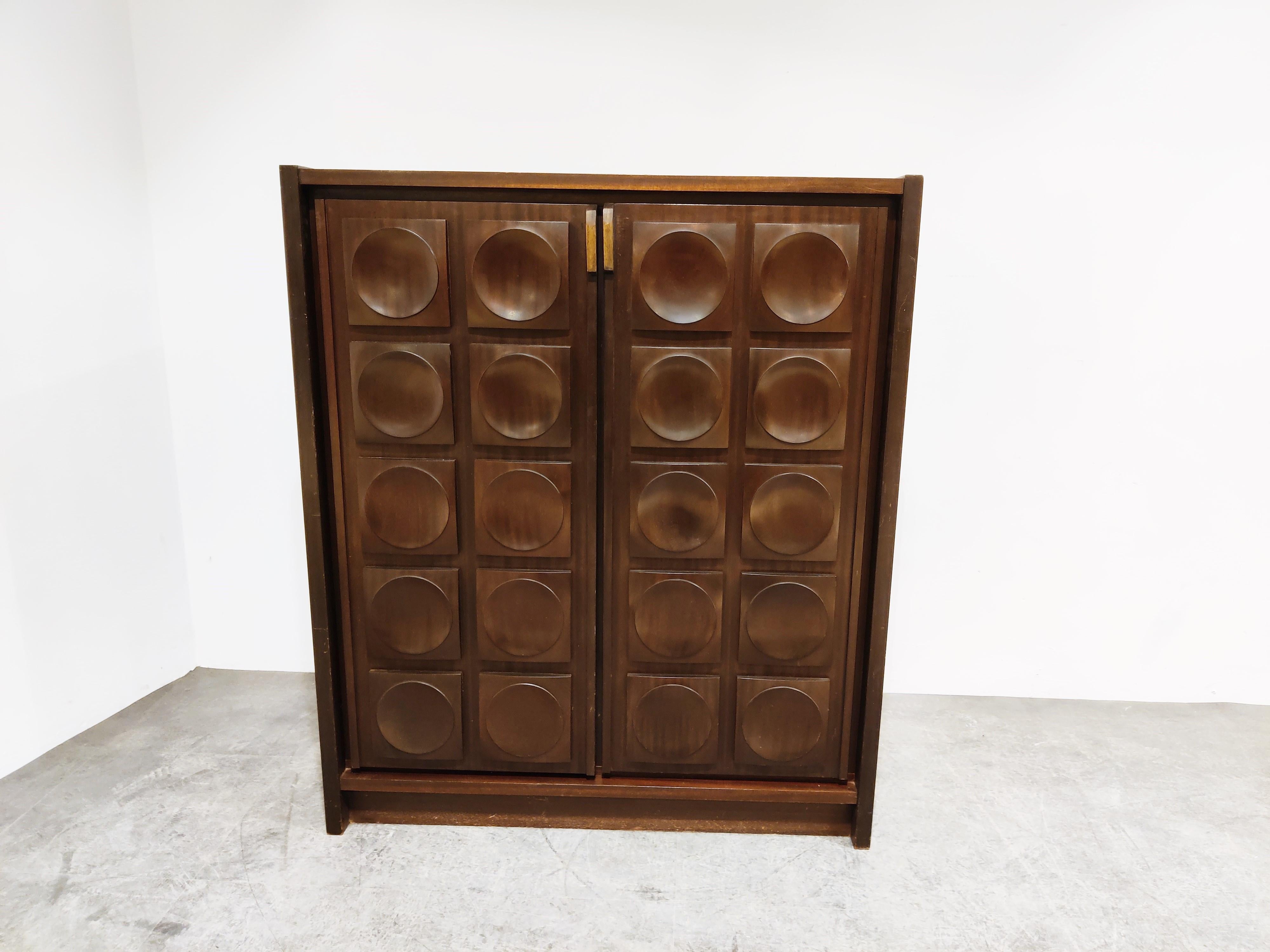 Note: The shown shipping rates are automatically generated by 1stdibs - this item needs a custom shipping quote, please contact us for delivery quotes.

Beautiful brown wooden brutalist bar cabinet.

Stunning graphical design doors.

Eye