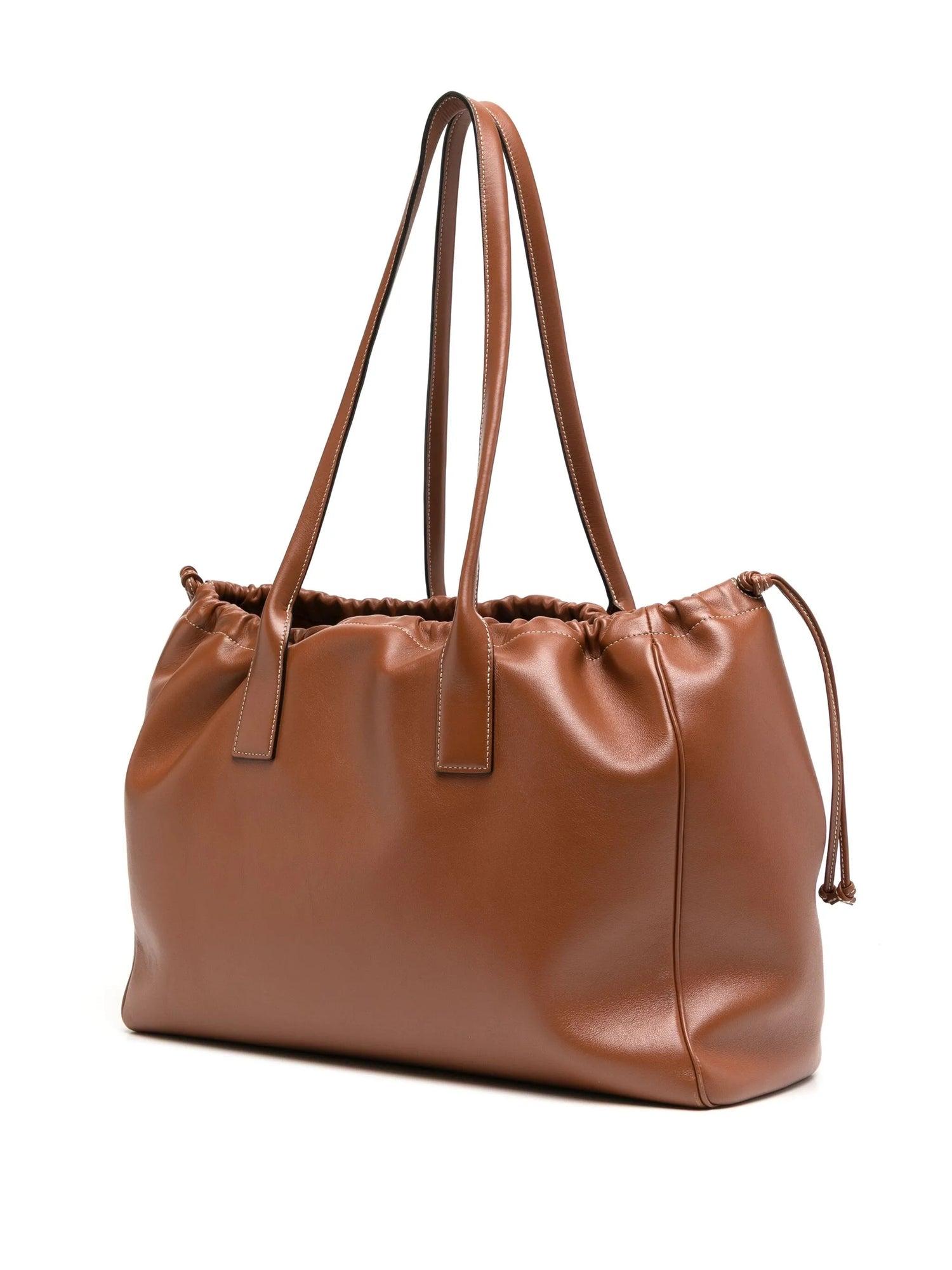 Tan brown
Smooth calfskin
Open top
Two tall top strap handles
Drawstring leather side ties
Main compartment
Suede leather interior
Hanging zipper pocket
Comes with dust bag
Condition: Excellent
This pre-loved bag is in excellent condition, with