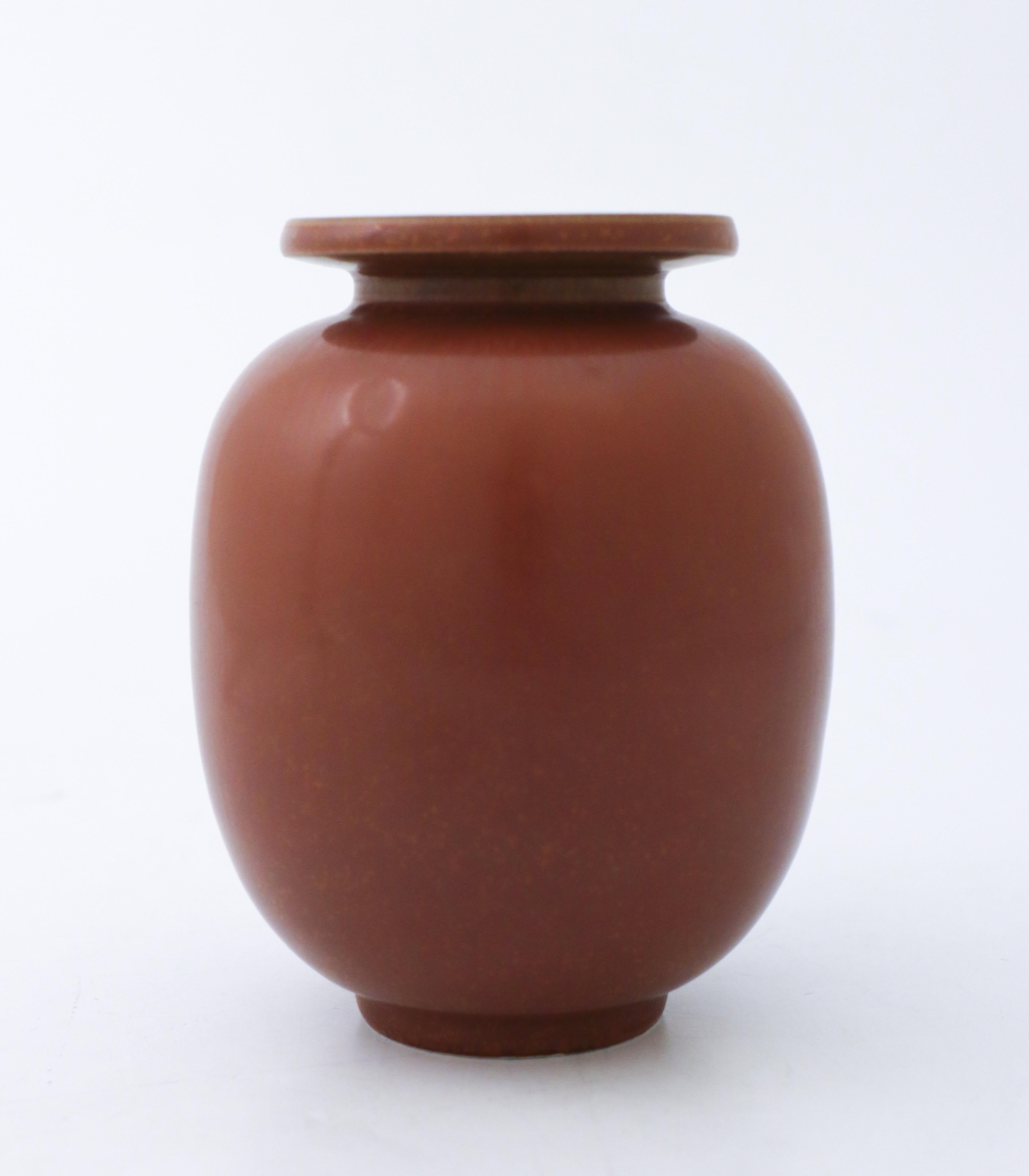 A brown vase designed by Gunnar Nylund at Rörstrand, it´s 13 cm (5.2) high. It´s in excellent condition and marked as 1st quality. 

Gunnar Nylund was born in Paris 1904 with parents who worked as sculptors and designer so he really soon started