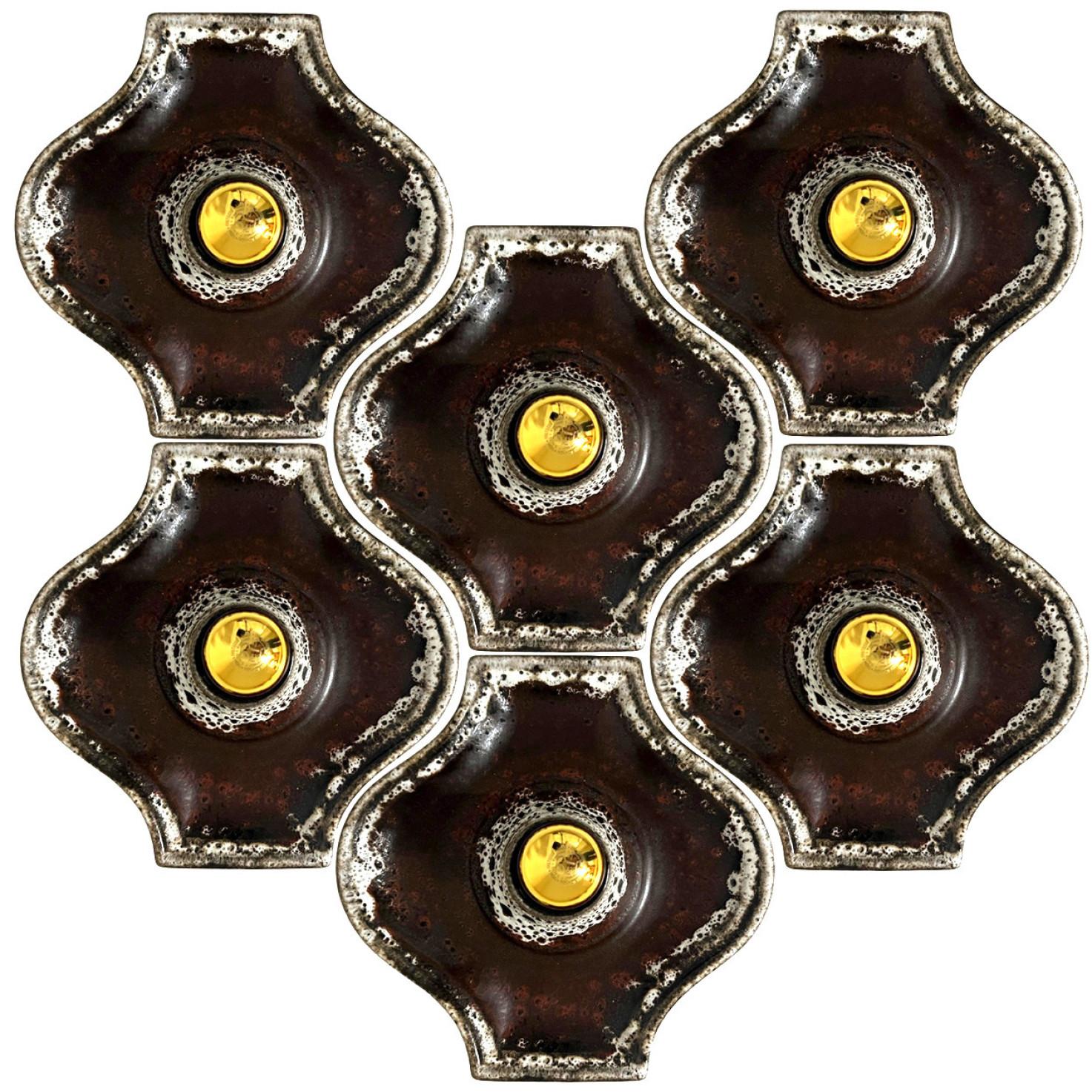 Brown ceramic wall lights in Fat Lava style. Manufactured by Hustadt Leuchten Keramik, Germany in the 1970s.

The style of the glaze is called 'Fat Lava'. Which means the glaze is thick on some parts, like lava.
A typical way to finish ceramic in