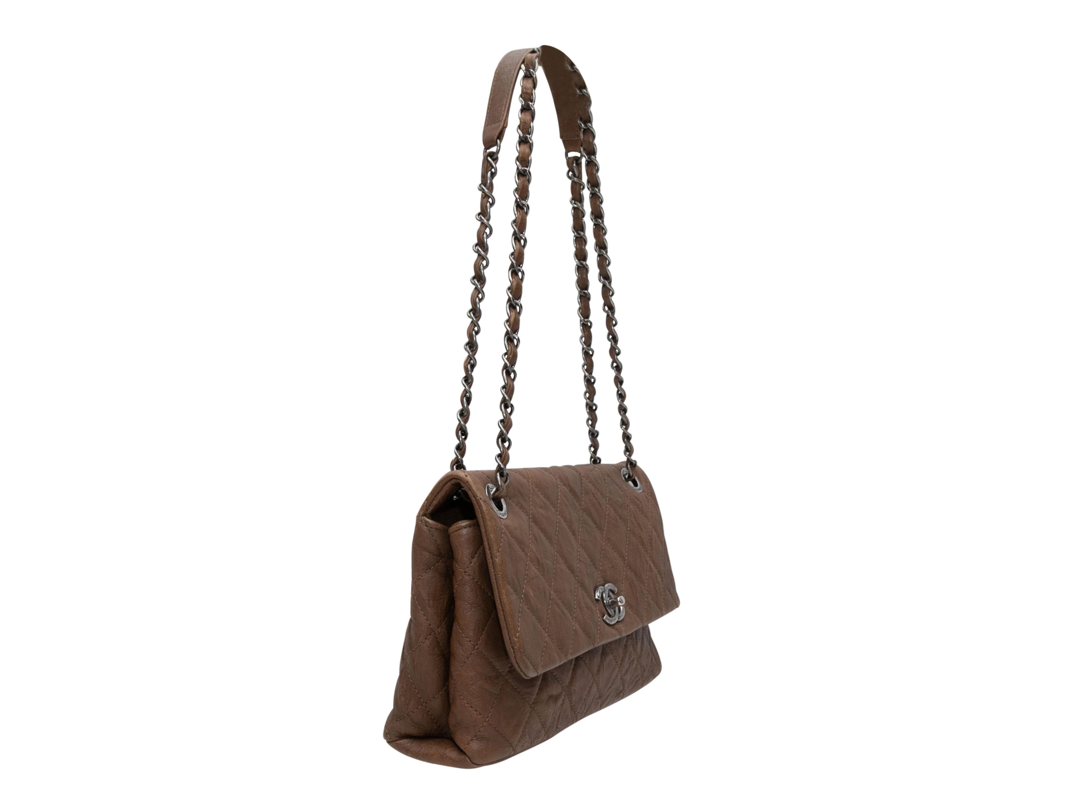 Brown Chanel 2015 Paris-Salzburg Collection Quilted Flap Bag. This handbag features a quilted leather body, silver-tone hardware, dual chain-link and leather straps, and a front CC turn-lock flap closure. 7