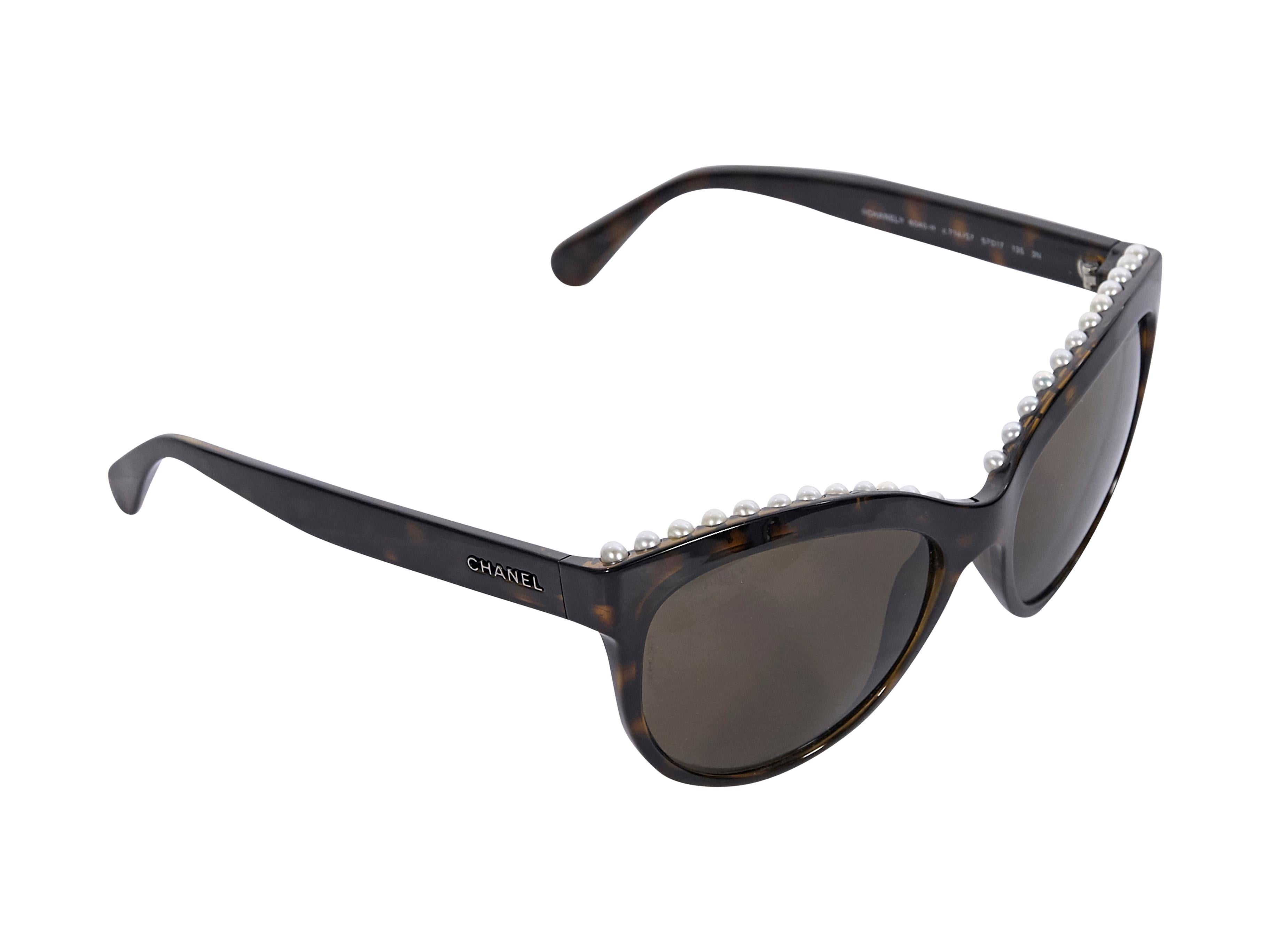 Product details:  Brown tortoiseshell cat-eye sunglasses by Chanel.  Trimmed with faux pearls.  Logo detail at temples.  2.5