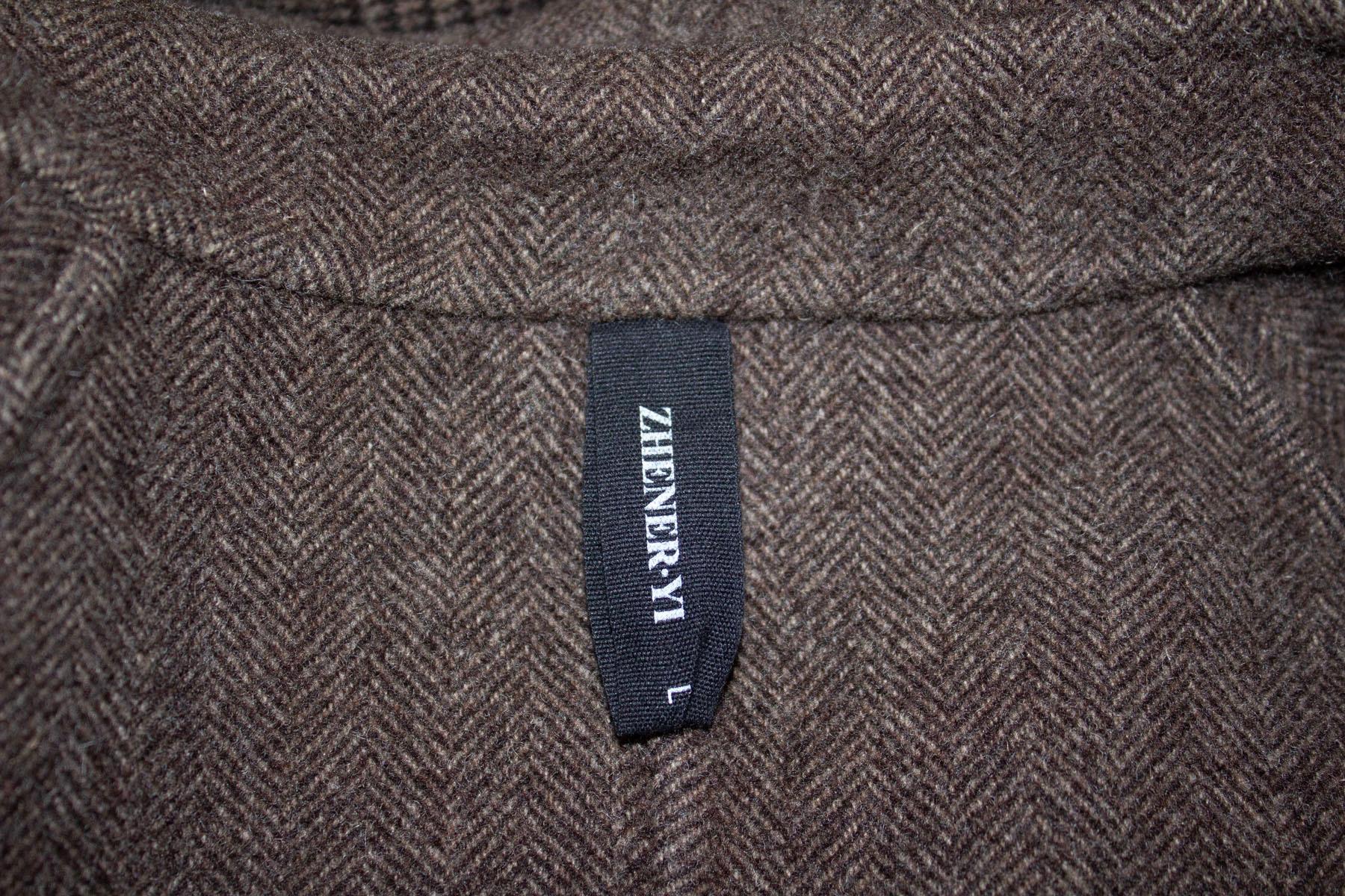 A great wool coat for Fall by Zhenery.In a brown wool check, the coat is double breasted with two pockets and is unlined.  100 % wool , excellent condition. Measurements: Bust up to 39'', length 41''