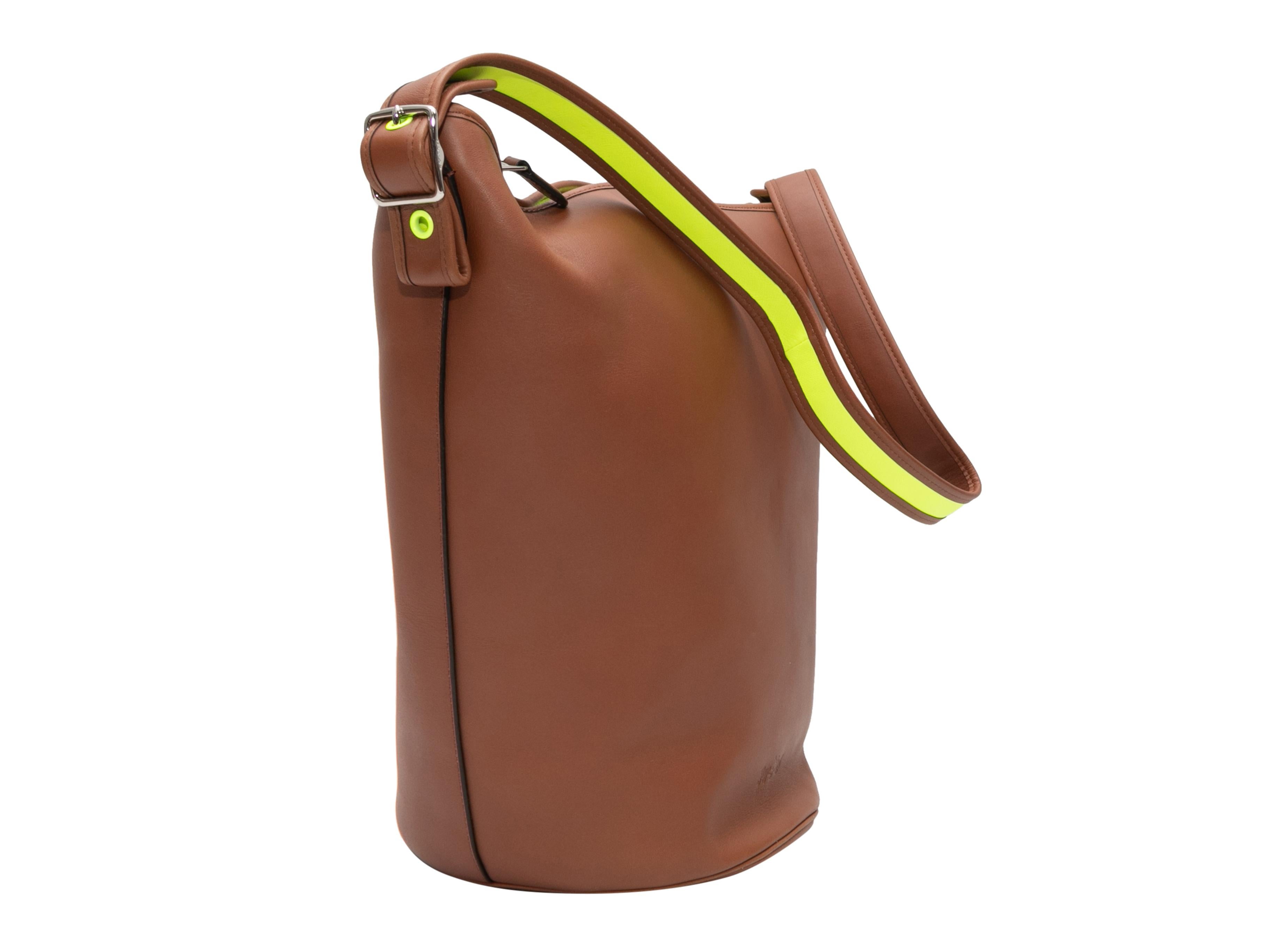 Brown Coach 2014 Duffle Sac Bag. The Duffle Sac Bag features a leather body, silver-tone hardware, neon green interior, a single flat shoulder strap, and a top zip closure. 14