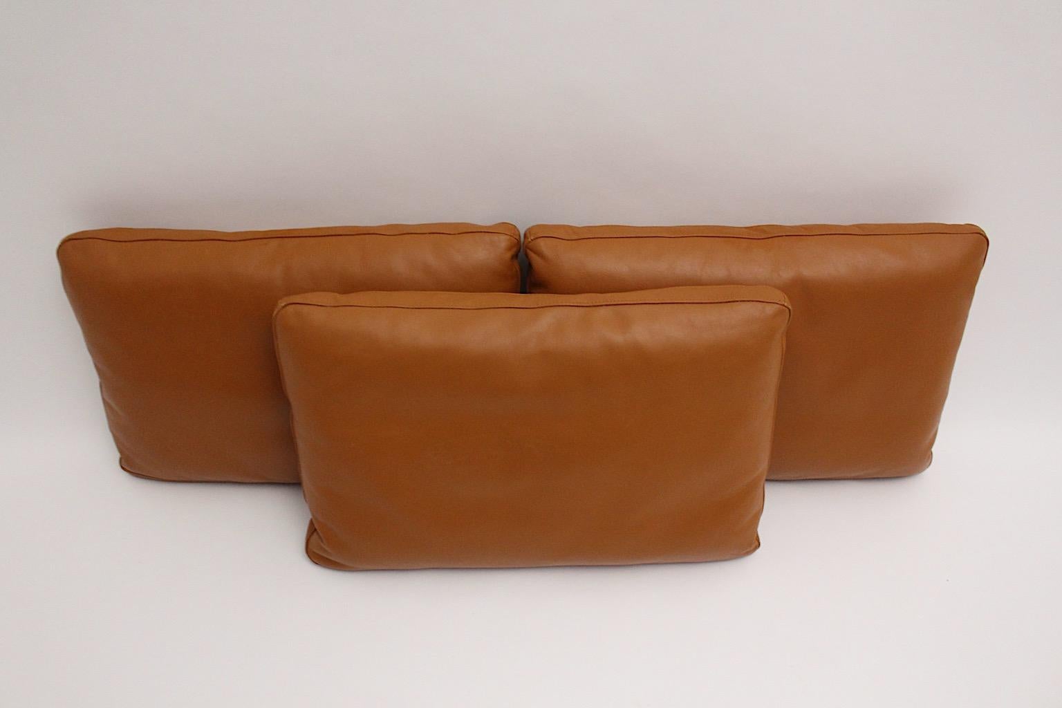 A cognac brown stitched vintage leather set of 3 large pillows, which were made in Switzerland, 1970s.
The set of 3 leather pillows shows large dimensions with width 74 cm x length 48 cm x depth 14 cm.
We love these pillows for its soft leather