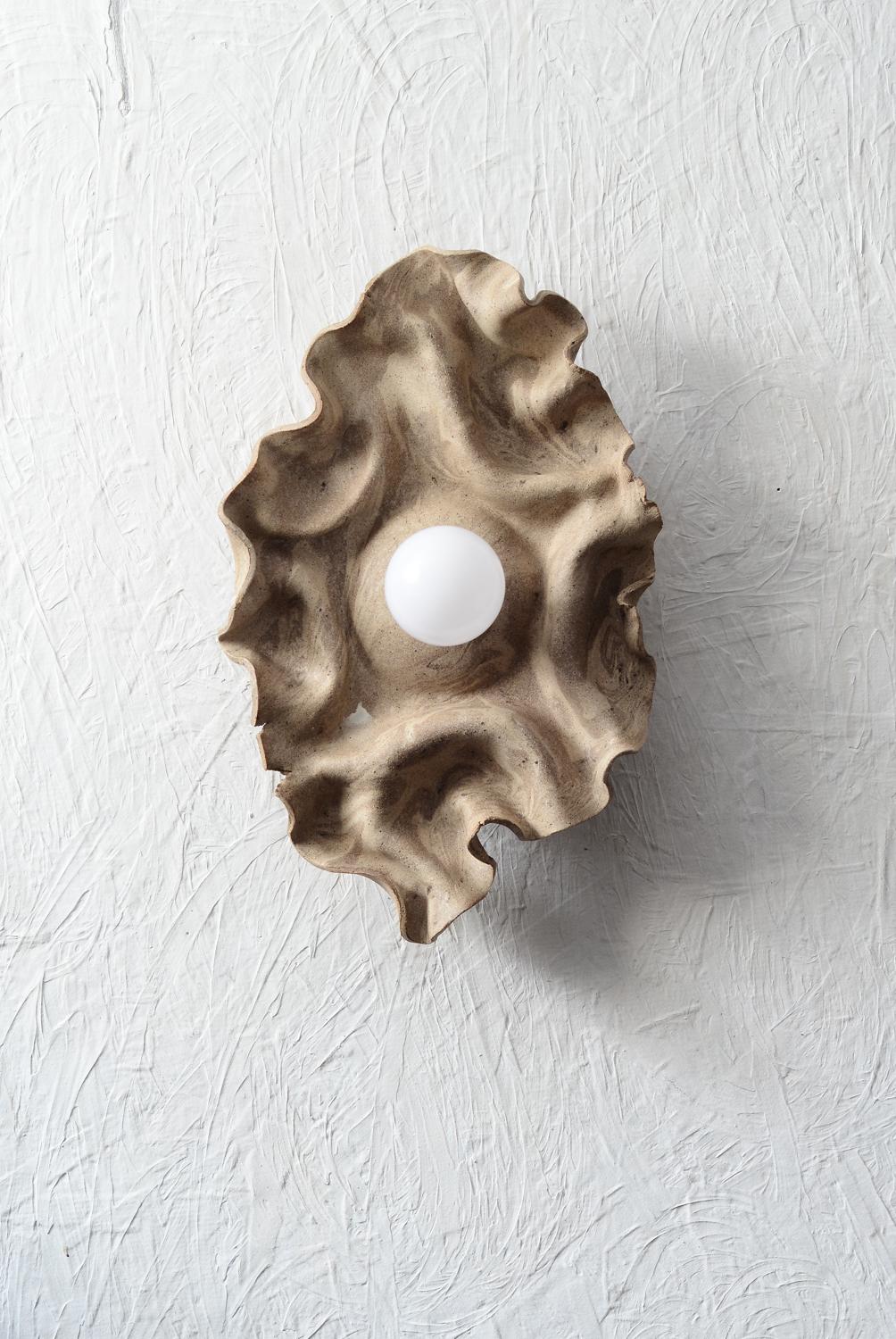 Handbuilt ceramic wall sconce with draped/folded  marbled stoneware clay, reminiscent of the natural world.
Meticulously crafted by the artist, The nature of the technique used to shape the clay adds a touch of uniqueness to each piece.
The sconce