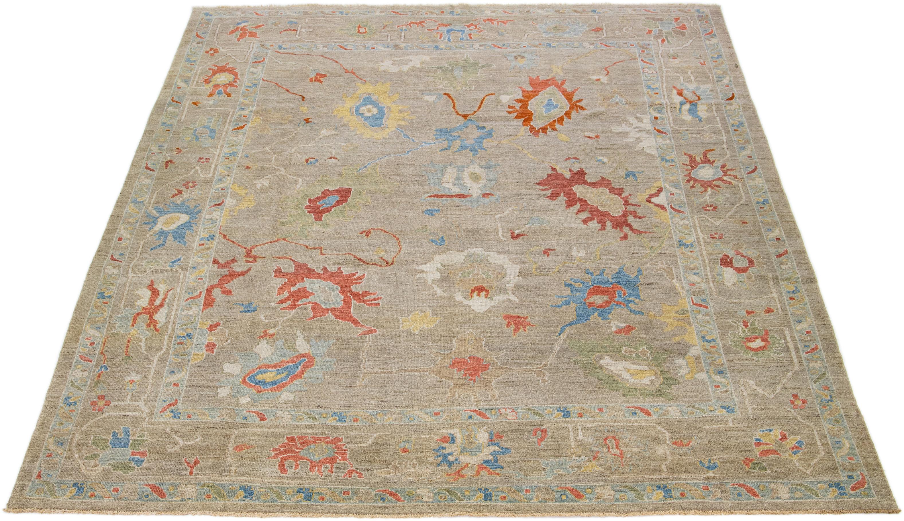 This modern reinterpretation of timeless Sultanabad design is beautifully manifested in an exquisitely hand-knotted wool rug, resplendent in its striking light brown shade. An intricate border delineates its all-over floral embroidery, embellished