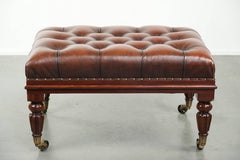 Brown cowhide Chesterfield ottoman in English style with ornate legs