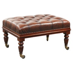 Brown cowhide Chesterfield ottoman in English style with ornate legs