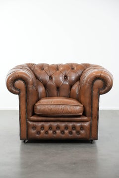 Brown cowhide leather chesterfield armchair in English style on wheels