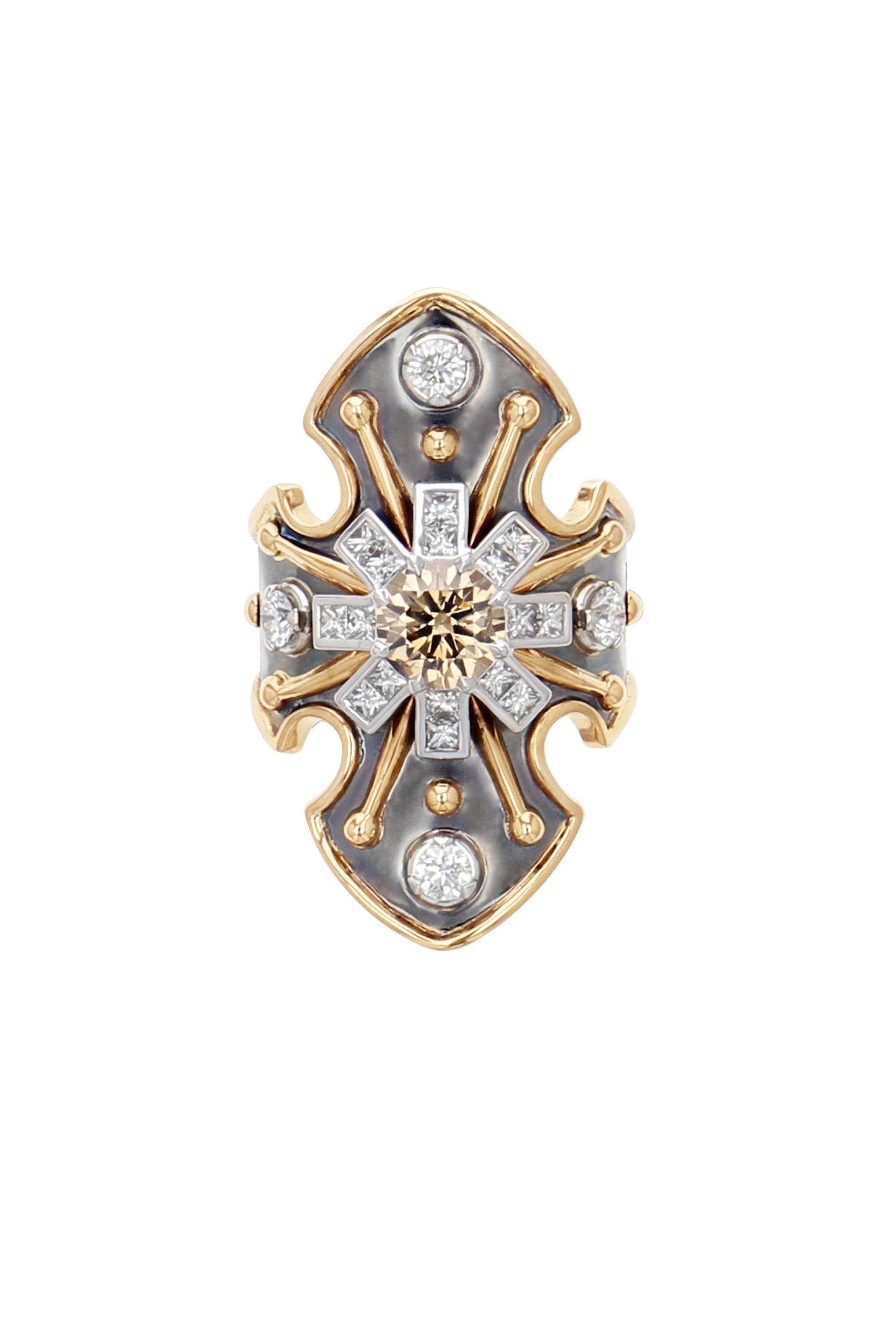 Yellow gold and distressed silver ring studded with a round brown diamond surrounded by diamonds and set on a white gold star.

Details:
Brown Diamond: 1.12 cts  
Diamonds: 0.94 cts
18k Yellow & White  Gold: 6.32g 
Distressed Silver: 6g  
Made in