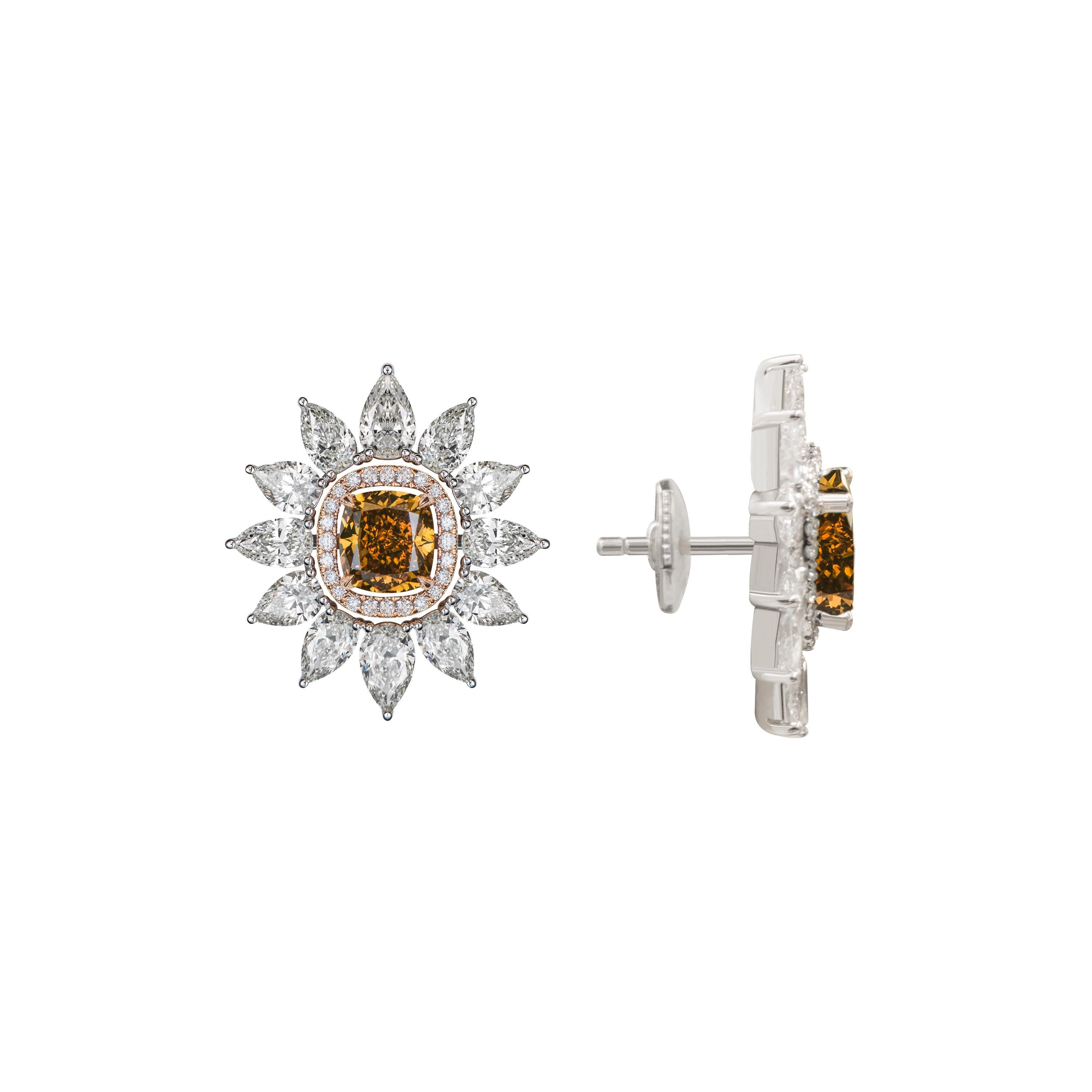 These innovative earrings allow you to wear them in two different combinations. The halo of pear shaped diamonds is detachable. The brown diamond solitaires in the center can be either worn by themselves or with the halo making this piece a