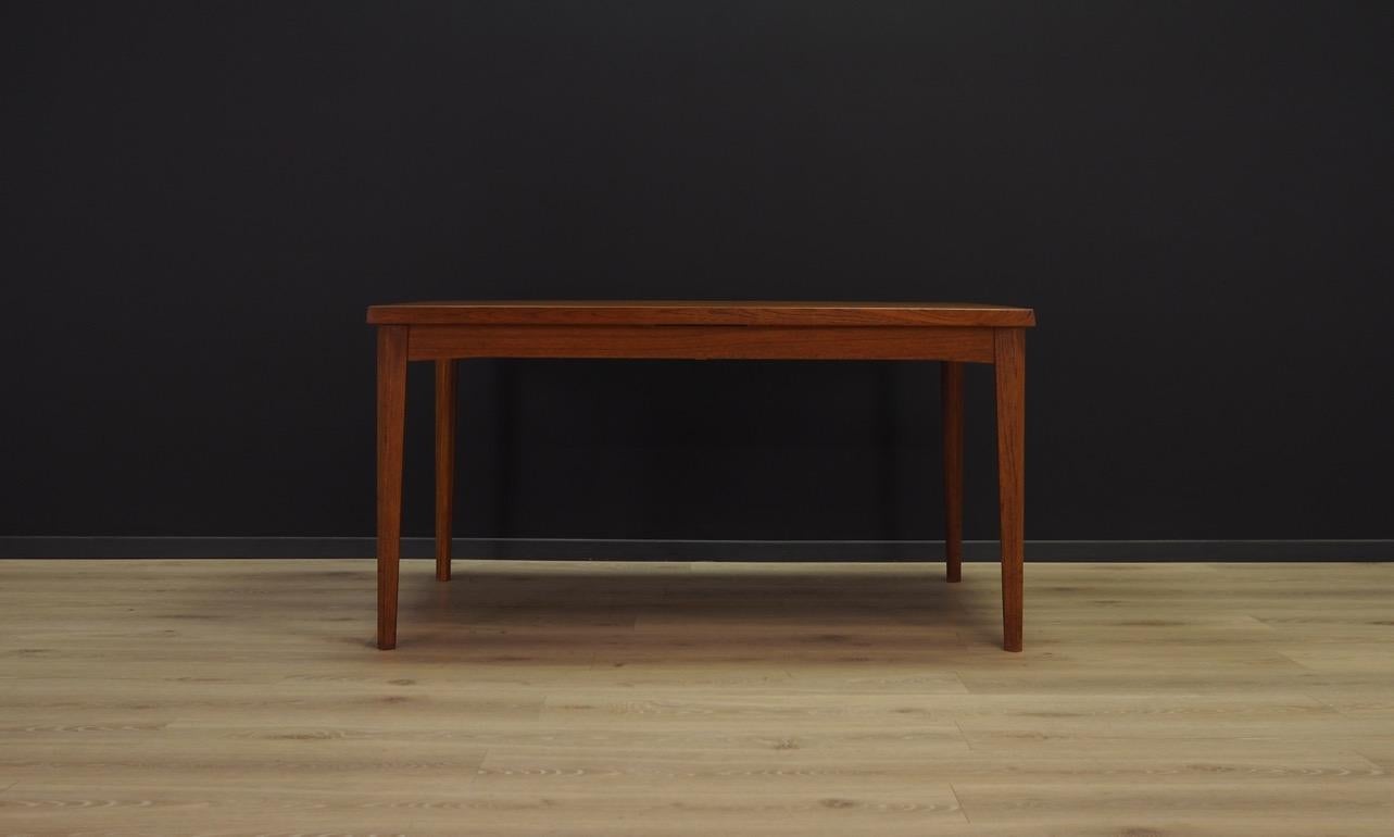 Amazing table from the 1960s-1970s, a beautiful Minimalist form, Danish design. Tabletop teak veneered, solid teak wood legs. Item has two inserts under the countertop. Preserved in good condition (visible bruises and tracing), directly for