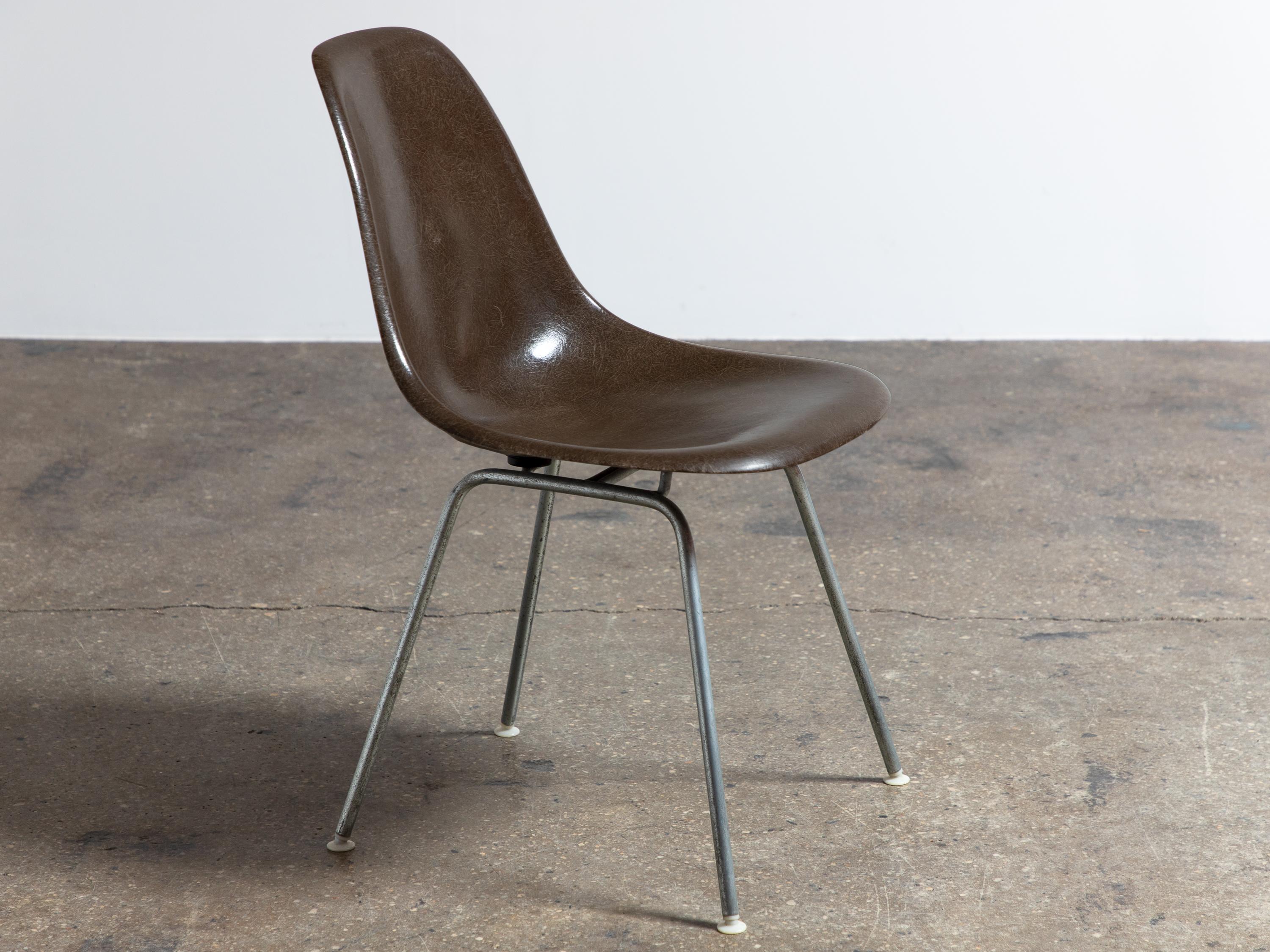 We have eleven original 1960s Eames fiberglass shell chairs with original H bases. Narrow mount. Lovely rich brown color. These have their original finish and are gorgeous, gleaming, and super thready. All chairs are stamped. Additional base styles