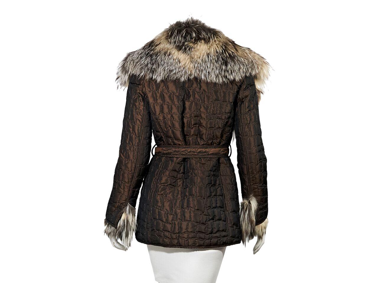 Product details:  Brown quilted coat by Escada.  Accented with metallic Lurex thread.  Trimmed with real silver fox fur.  Long sleeves.  Button-front closure.  Self-tie belted waist.  Waist slide pockets.  35