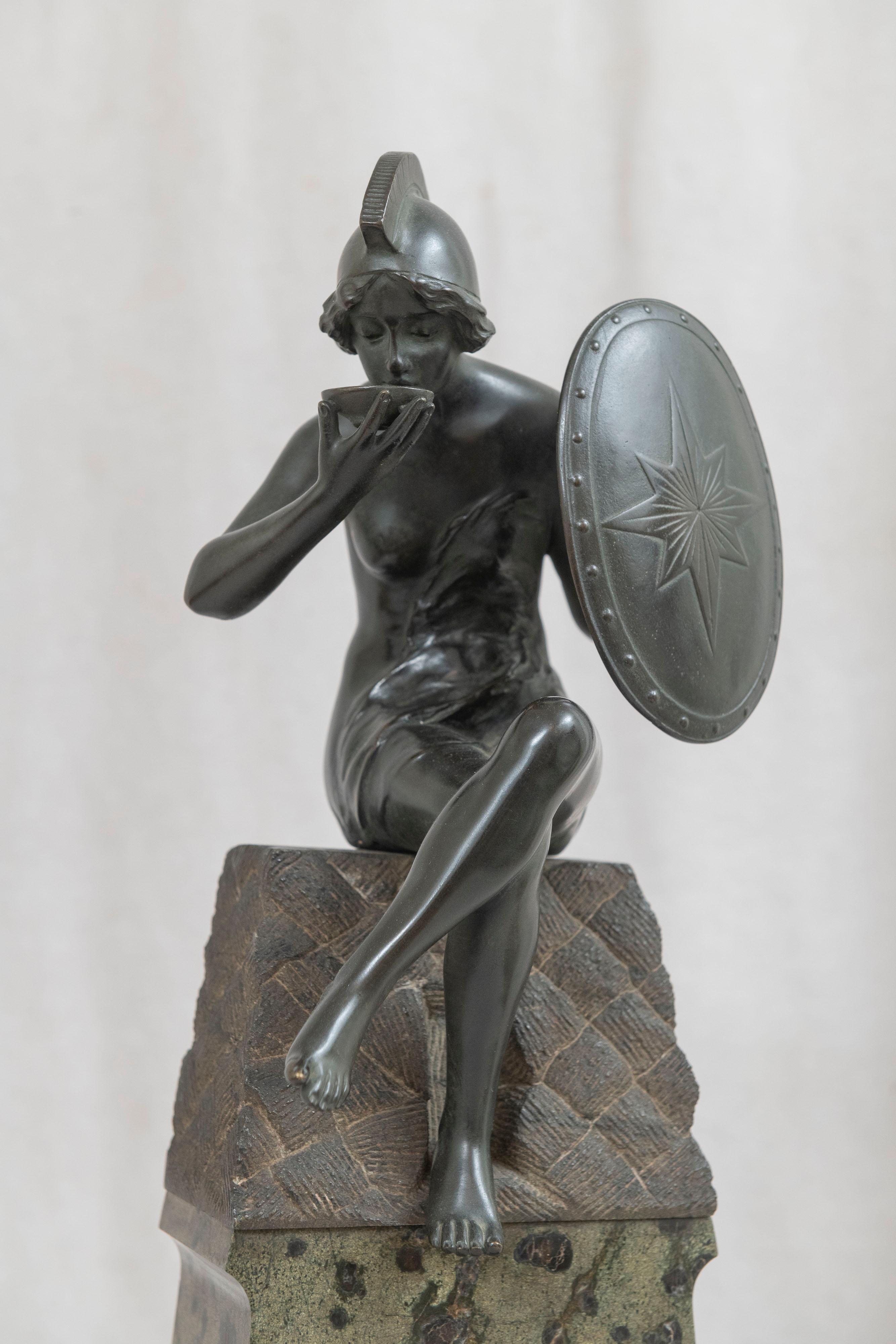 This unusual bronze really caught our attention. The seated female warrior perched high atop a marble base is a rare look in antique bronzes. The bronze itself is well cast and has a warm dark original factory patina. Where she sits looks like it