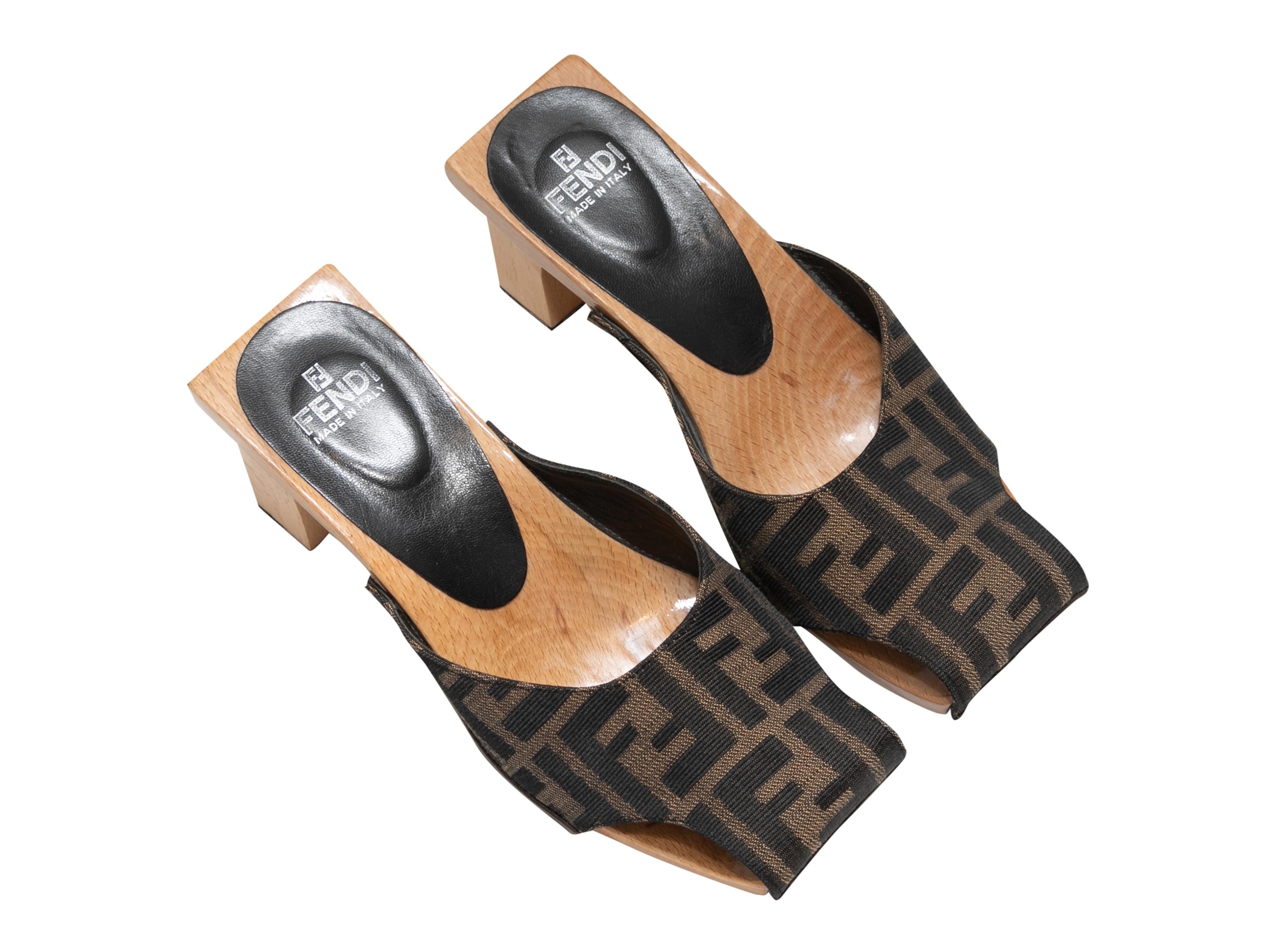 Product Details: Brown square-toe Zucca cutout heeled mules by Fendi. Wooden soles and heels. 0.75