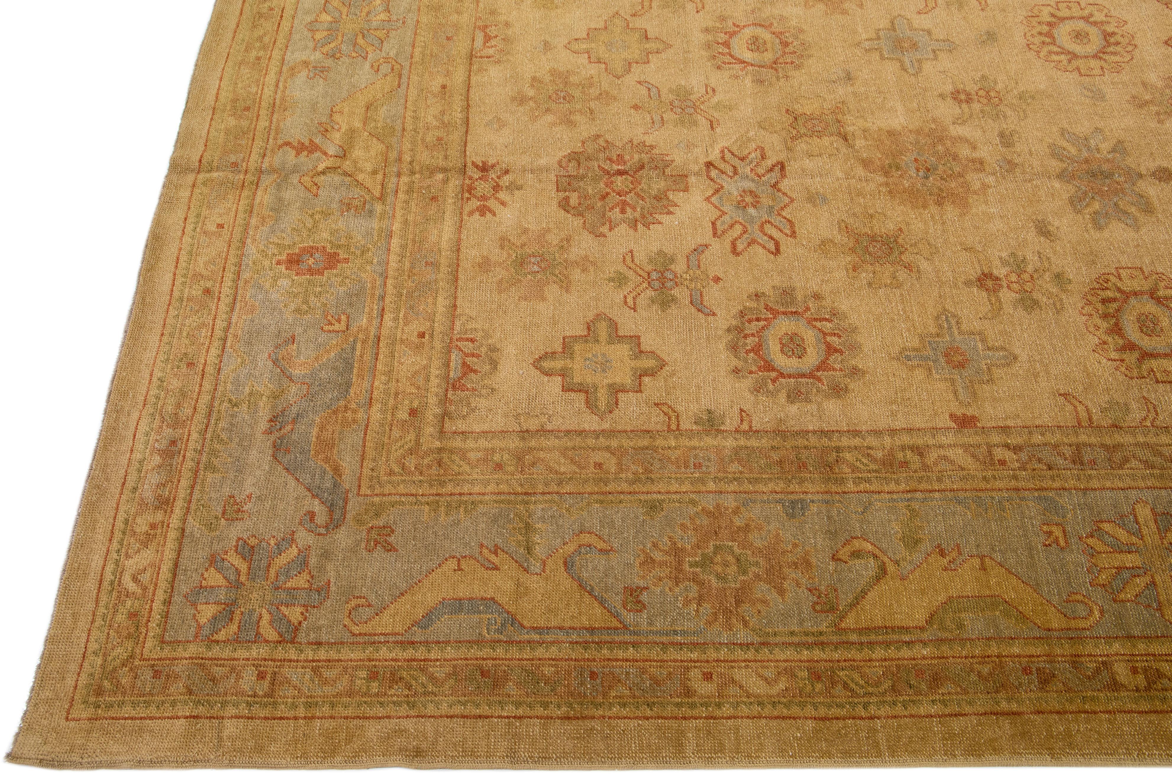Beautiful modern Turkish Oushak hand-knotted wool rug with a brown color field. This rug has green and gray accents in a gorgeous large-scale floral pattern.

This rug measures: 13'8