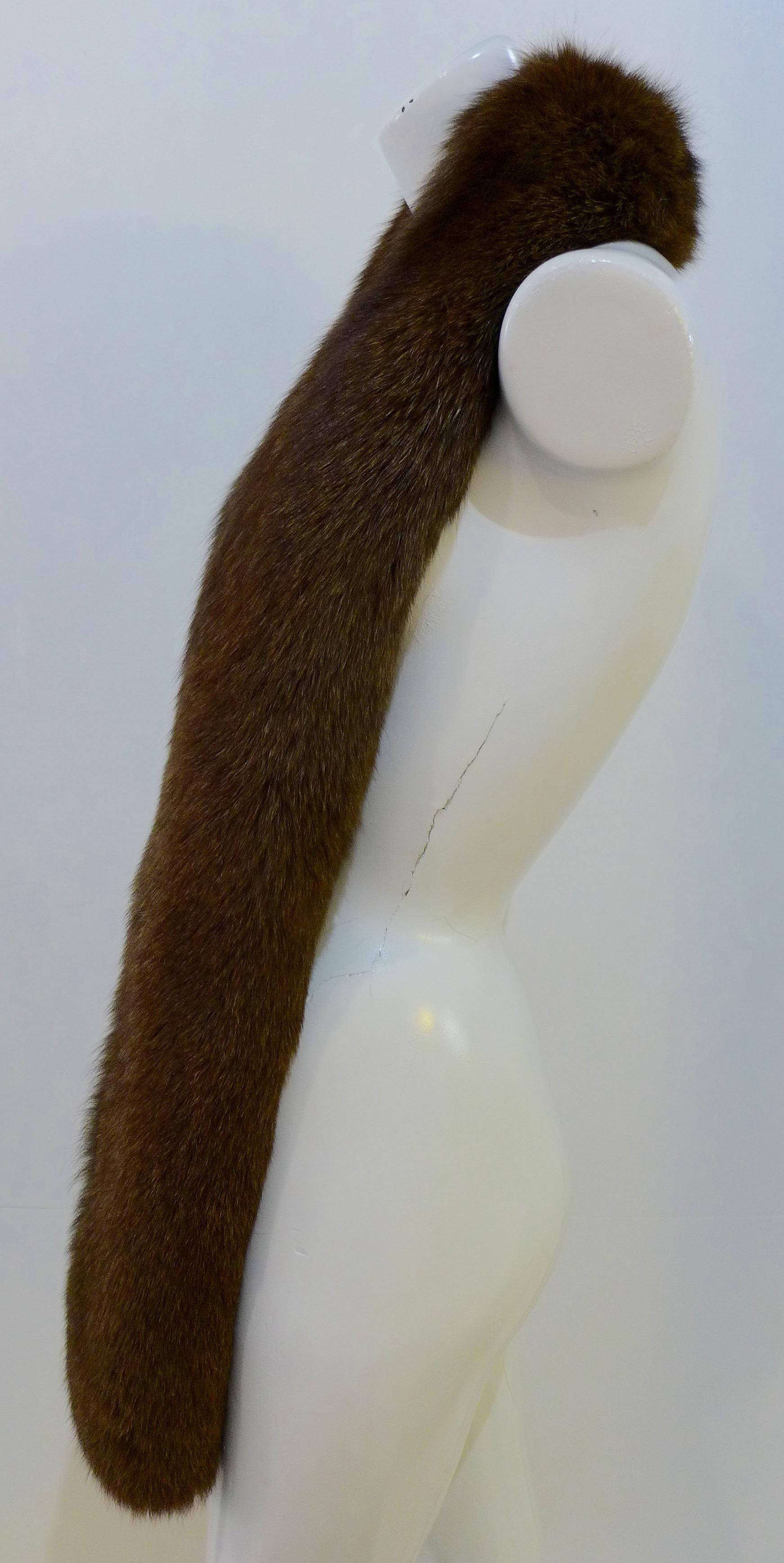 This vintage brown real fox fur wrap is in great condition. It has dark brown velvet lining, velvet inner straps, and a satin monogram patch. 

Measurements in Inches:
Width: 5 
Length: 72 