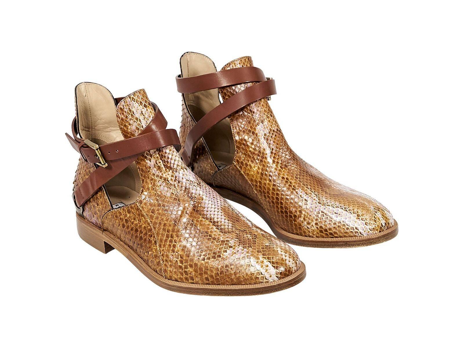 Product details:  Brown python ankle boots by Fratelli Rossetti.  Adjustable wrap-around ankle strap.  Cutout sides.  Round toe.  Goldtone hardware.
Condition: Pre-owned. Very good.
Est. Retail $738