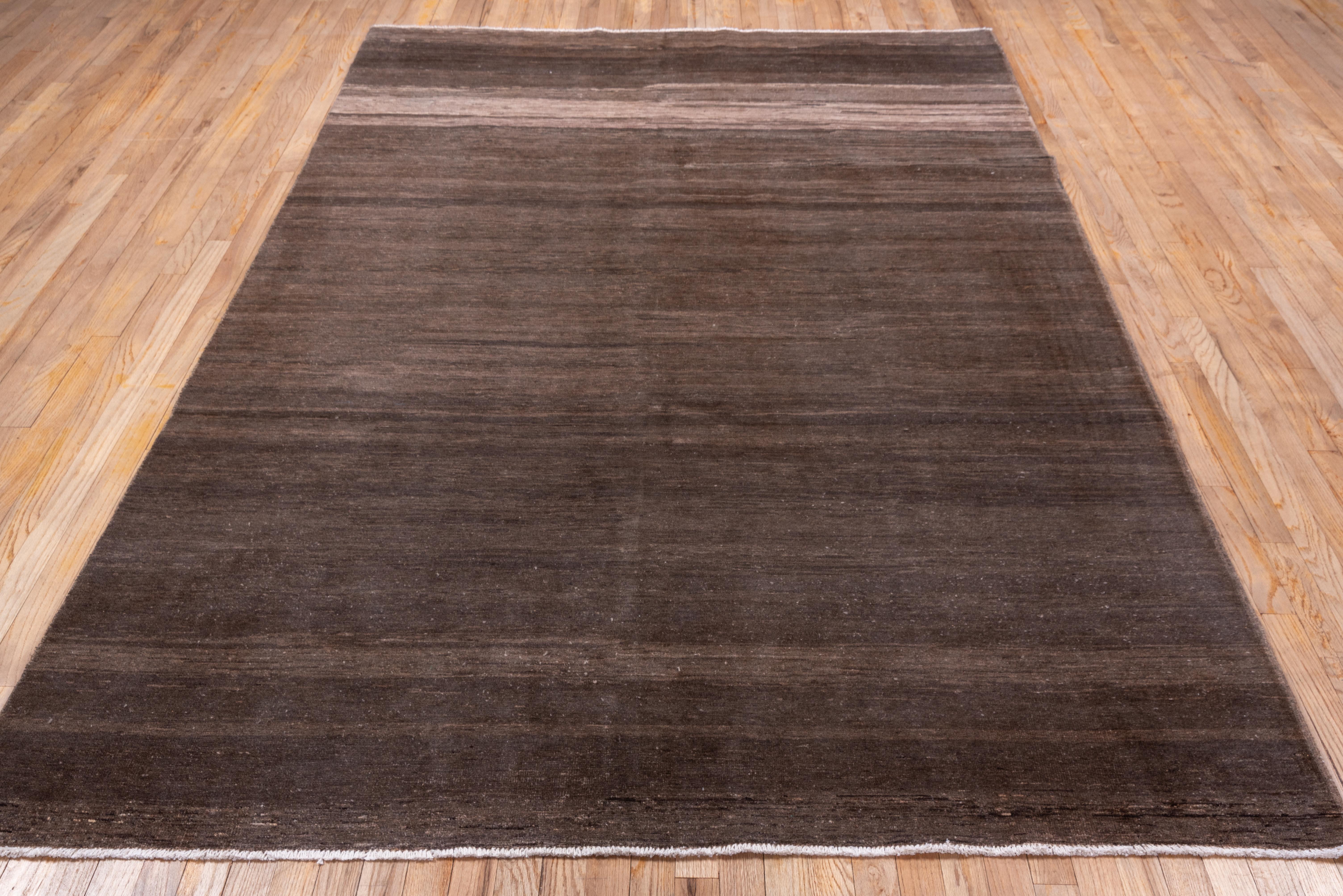 This totally plain, monochrome carpet is a study in well-abrashed natural browns ranging from almost chocolate to variegated beige's. The pile is relatively short, close and resilient.
