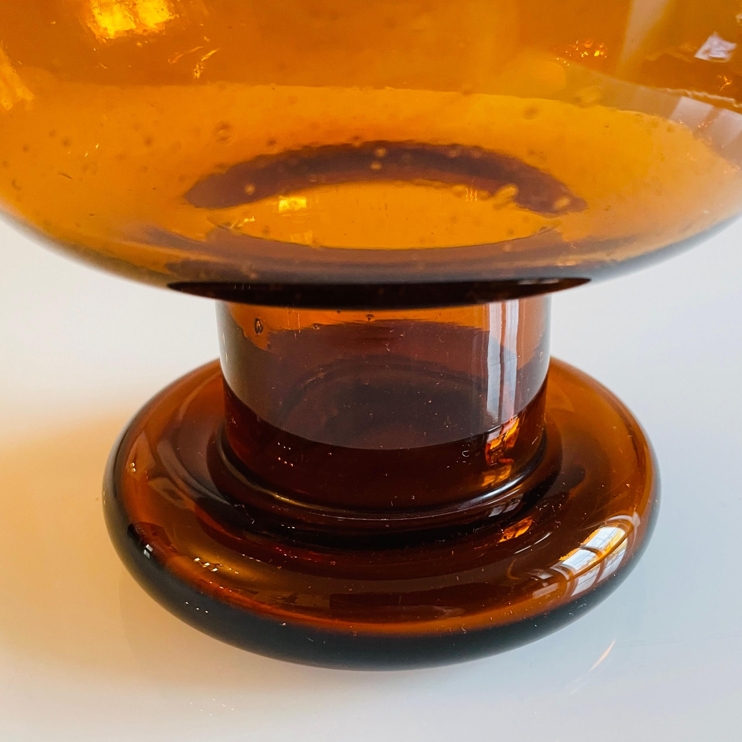 Nuutajärvi Glassworks' bowl with handle is part of the Sargasso glass collection designed by Kaj Franck in 1966. The glass bowl is made of brown bubble glass, also known as blister glass. The Sargasso bowl is suitable for serving anything from