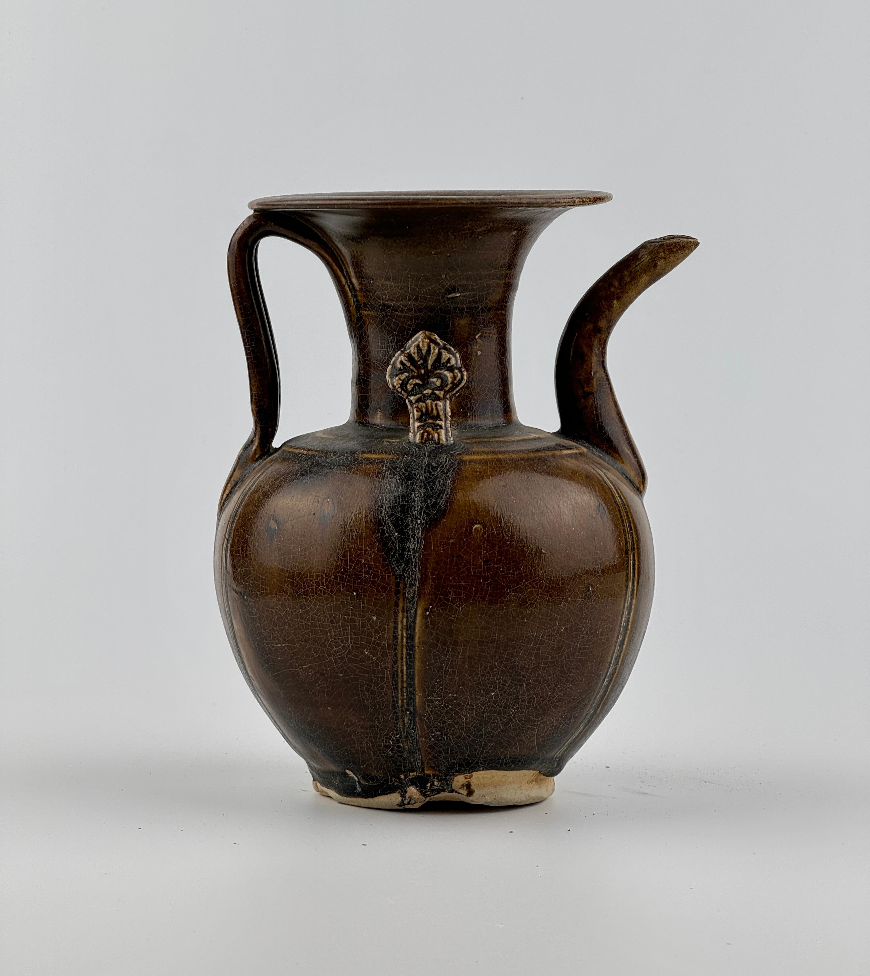 The glaze crackles, reflecting the passage of time, add to the piece's antique charm. The spout and handle are well-proportioned, and the brown glaze is evenly applied, the unique finger-sized ornamentation on the shoulders is a distinctive feature