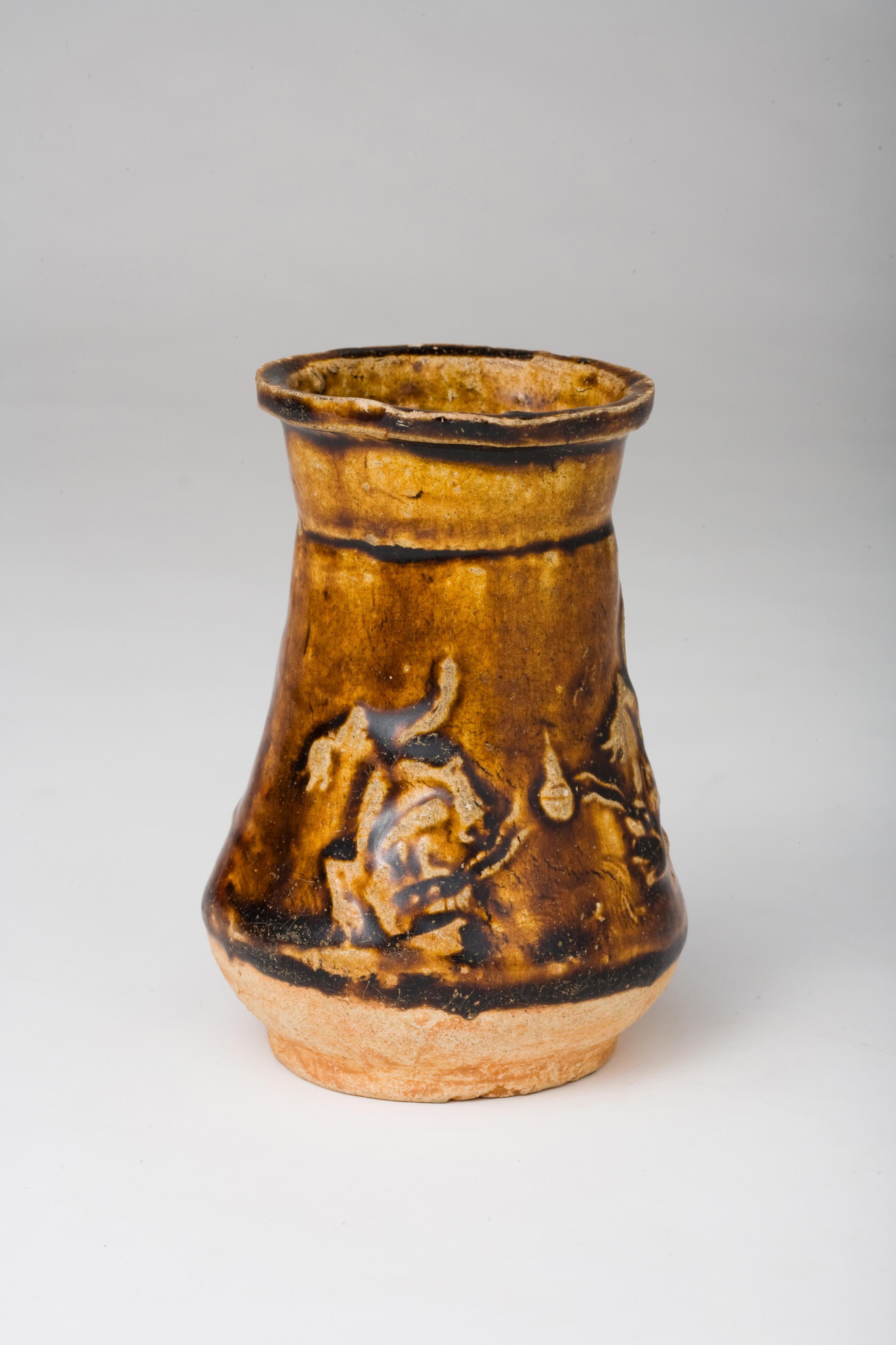 The glaze blends harmoniously with the color of the clay, giving a natural, earthy feel. This piece features intricate carvings of two dragon presumably pursuing a sacred jewel called 