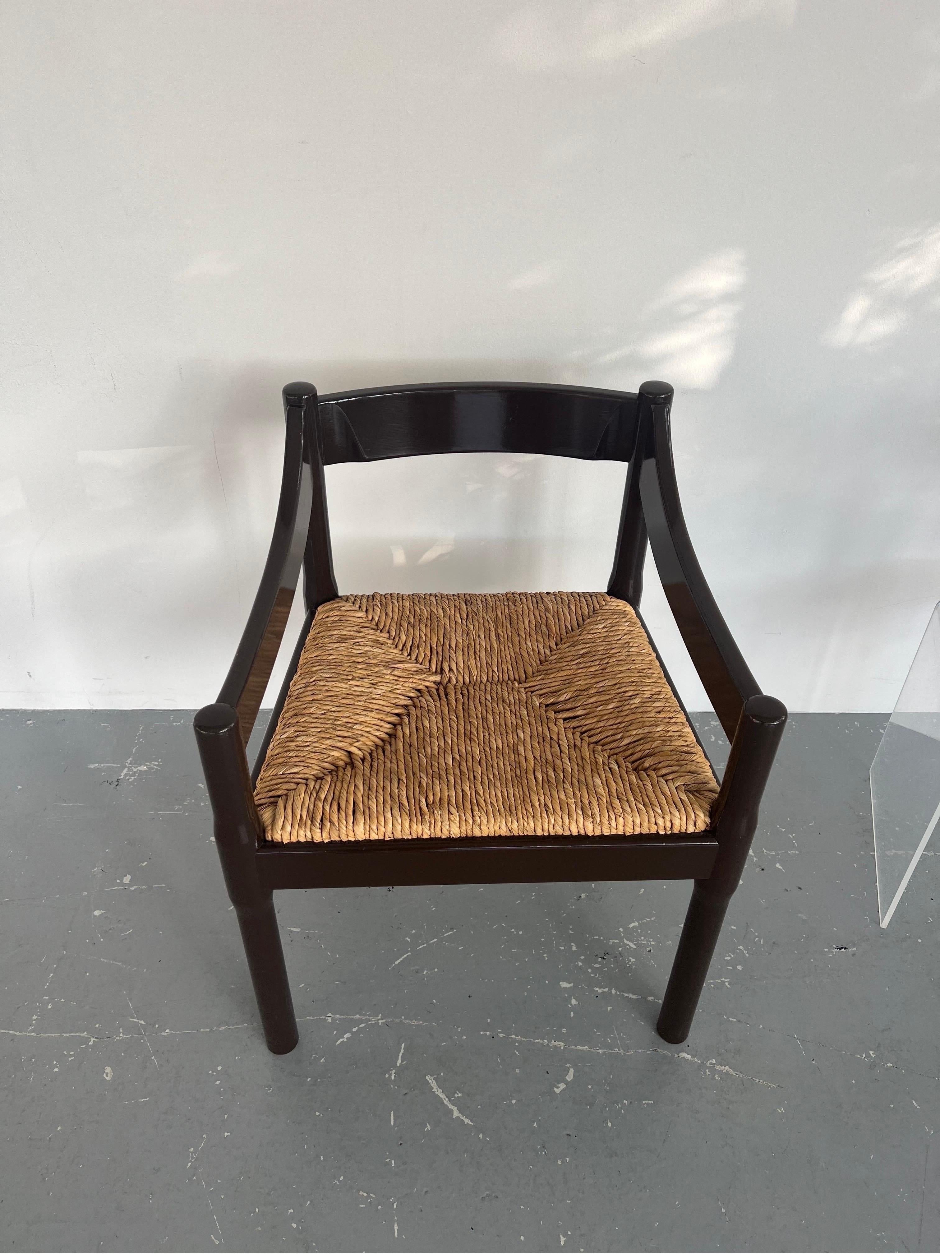 Charming chocolate brown painted solid Beech Carimate chairs designed by architect and designer Vico Magistretti. These chairs have been recently painted in a thick glossy paint, the paint job is very good, there are just a few very minor