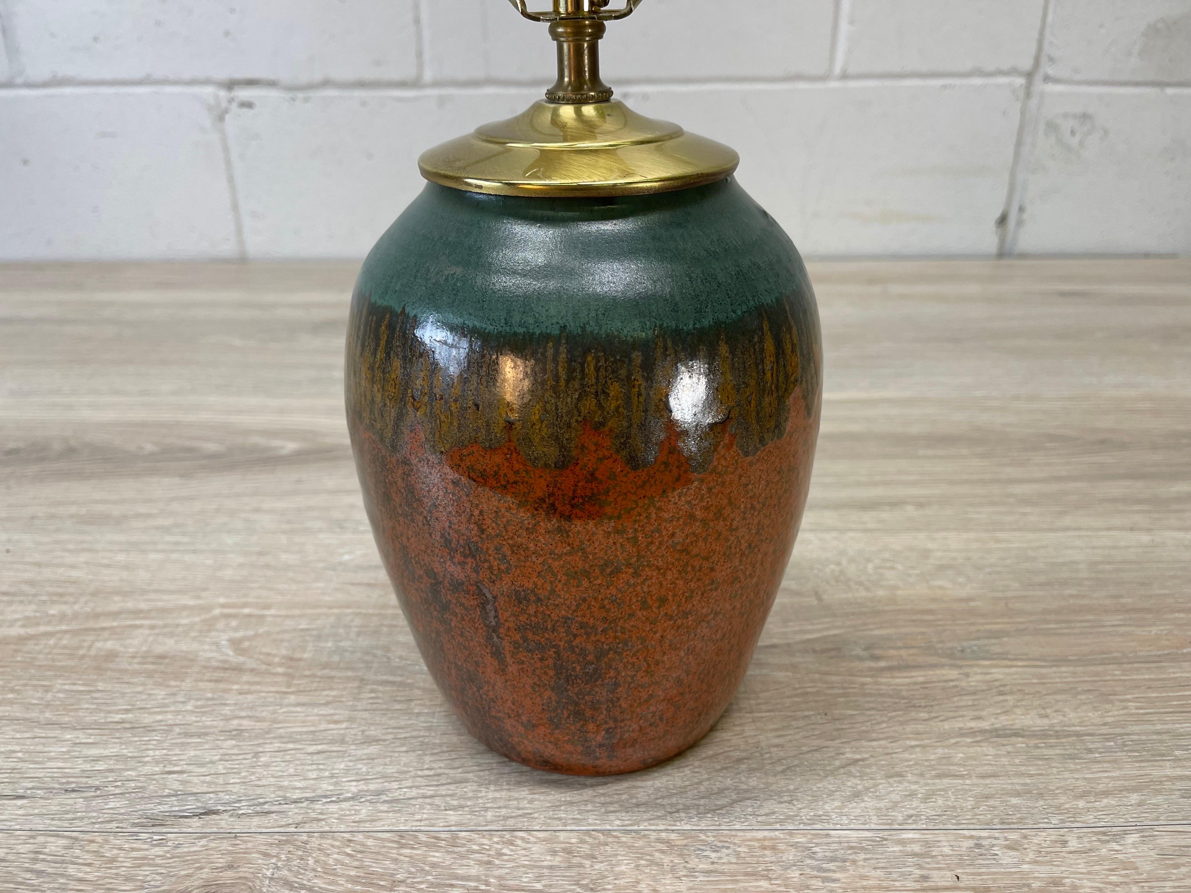 Vintage brown and green pottery table lamp. The lamp is wired for the US and in working condition. Socket, 12.5”H. Harp, 4”Diameter x 8”Height. Marked underneath.