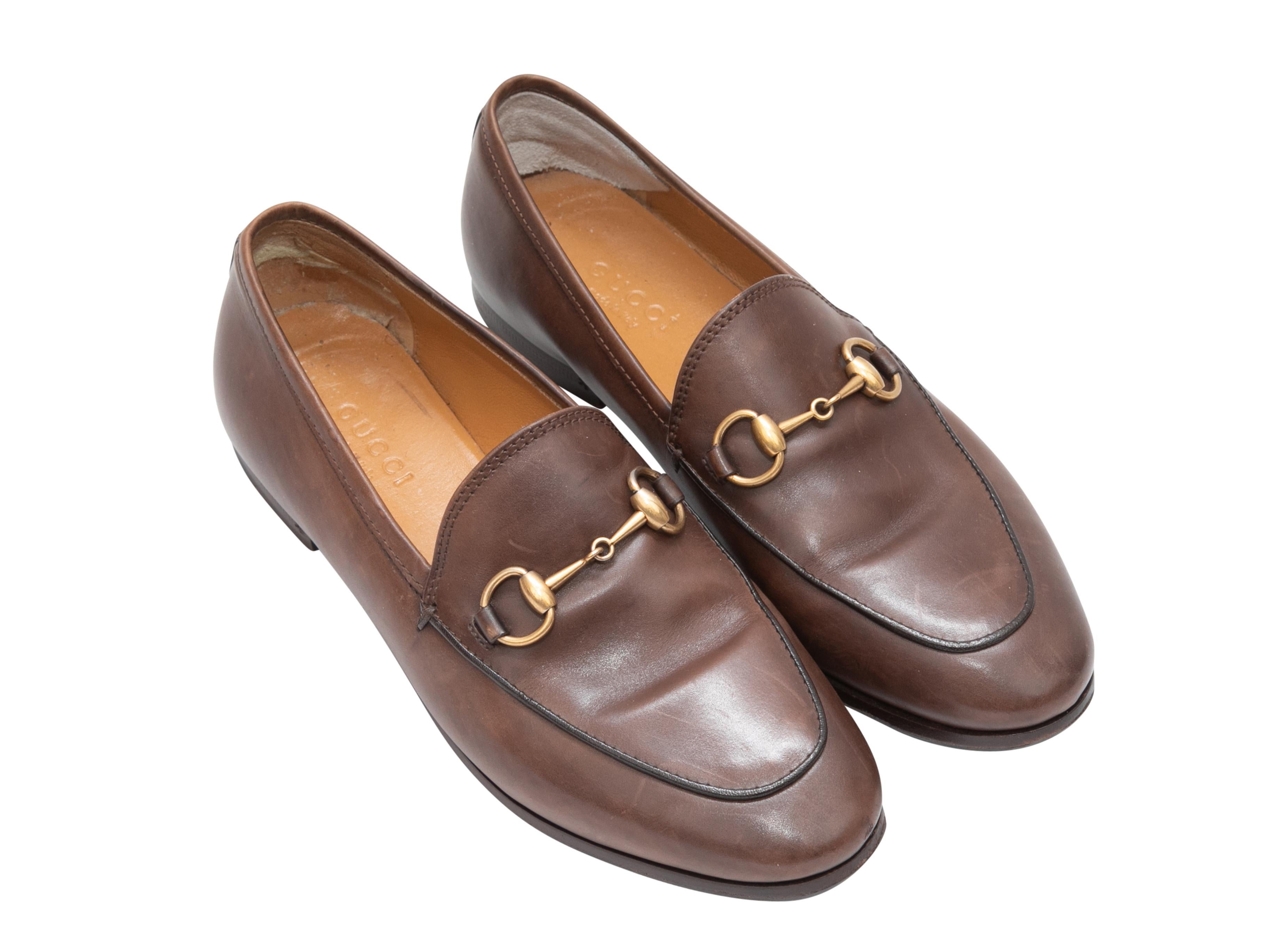 Brown leather Horsebit loafers by Gucci. Gold-tone hardware. 0.5