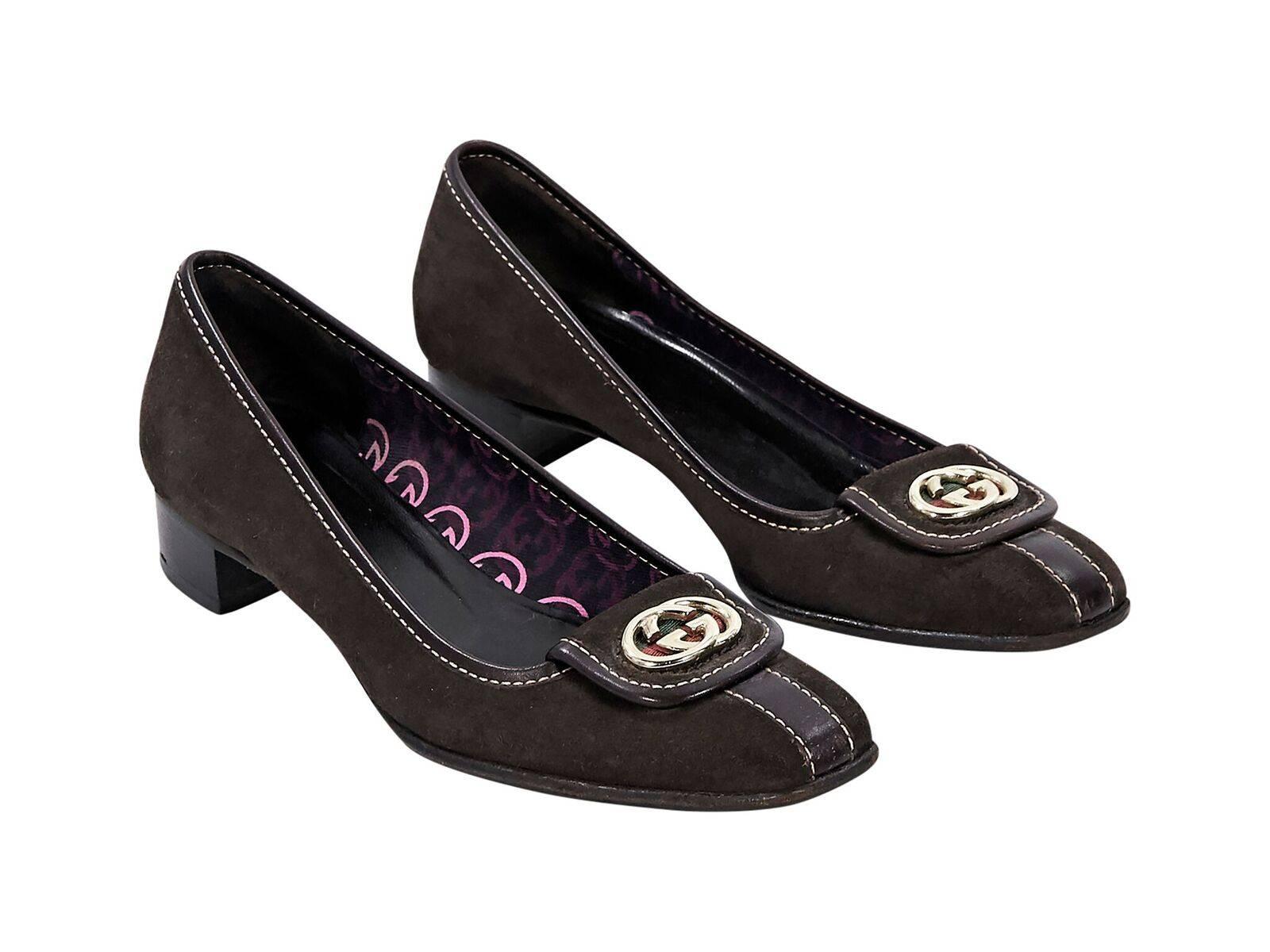 Product details:  Brown suede loafers by Gucci.  Trimmed with leather.  Logo detail accents vamp.  Low stacked kitten heel.  Slip-on style.  Goldtone hardware.  
Condition: Pre-owned. Very good. 
Est. Retail $795