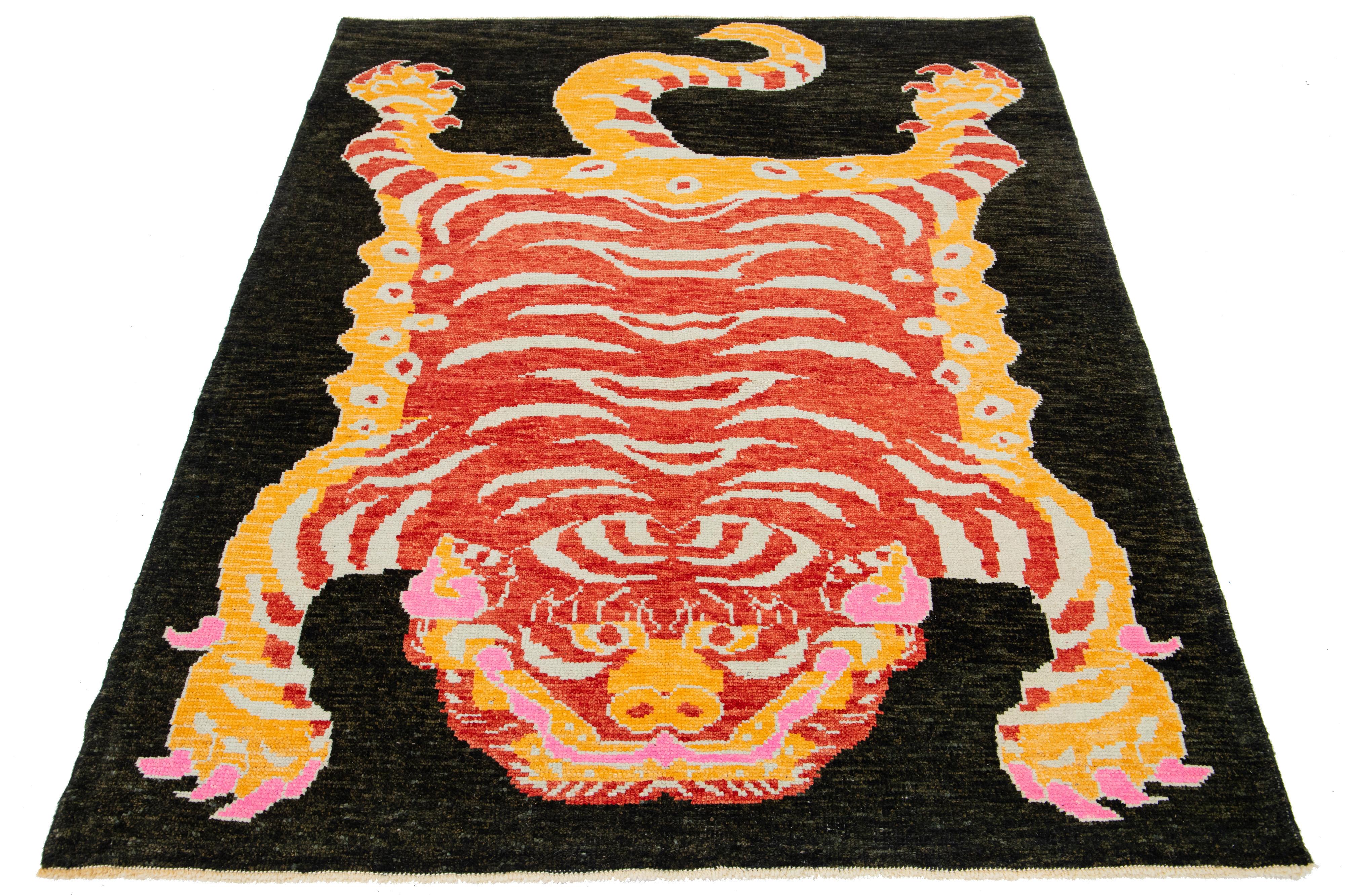 This beautiful Turkish Art Deco wool rug features a dark brown field with orange, red, beige, and pink accent colors and a stunning tiger pictorial design.

This rug measures 5'5