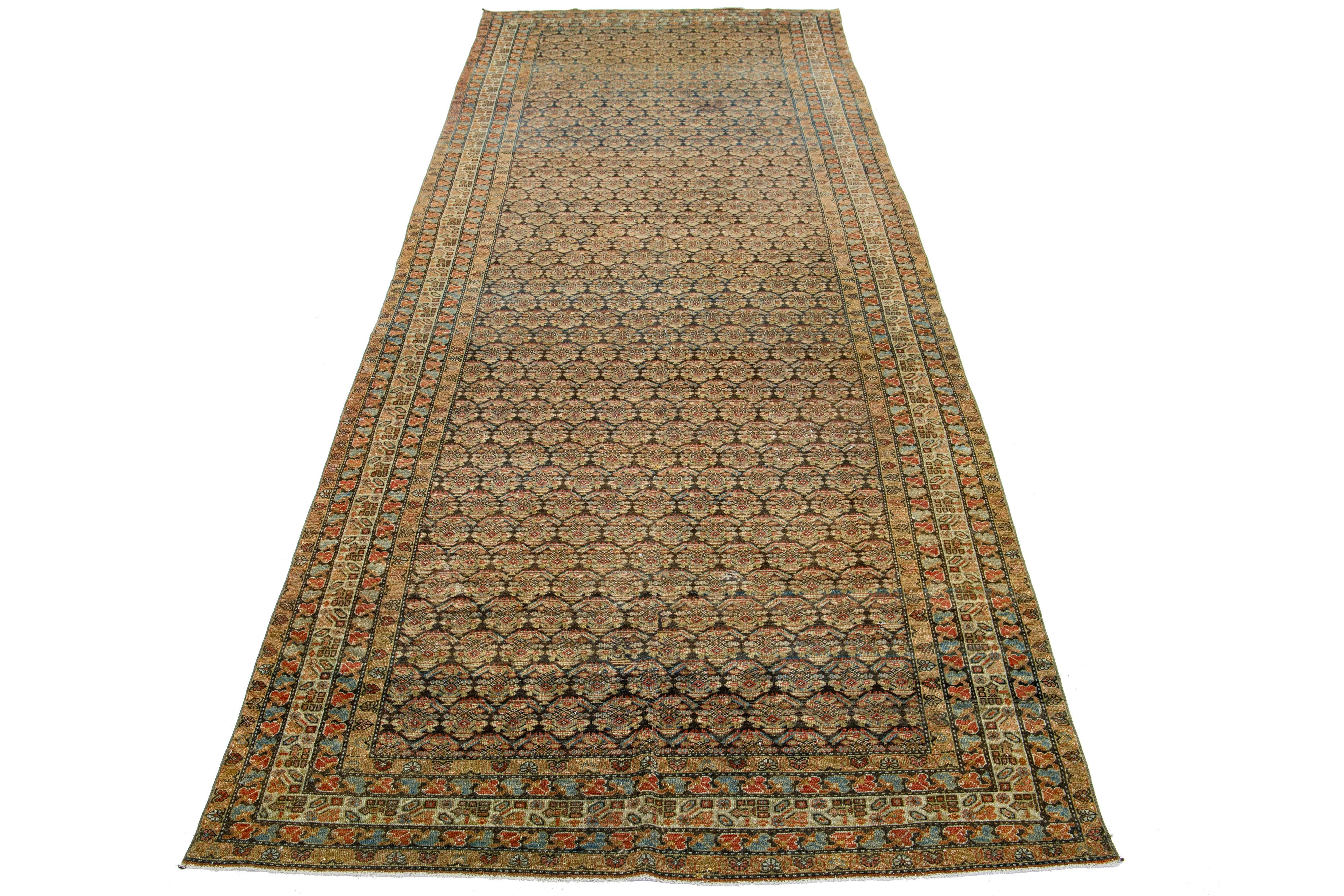 Dieser außergewöhnliche antike persische Malayer-Teppich ist aus handgearbeiteter Wolle gefertigt. Das Design des Teppichs zeigt eine Kombination aus Blau und Braun als Basis, die mit beigen und rostfarbenen Highlights in einem bemerkenswert