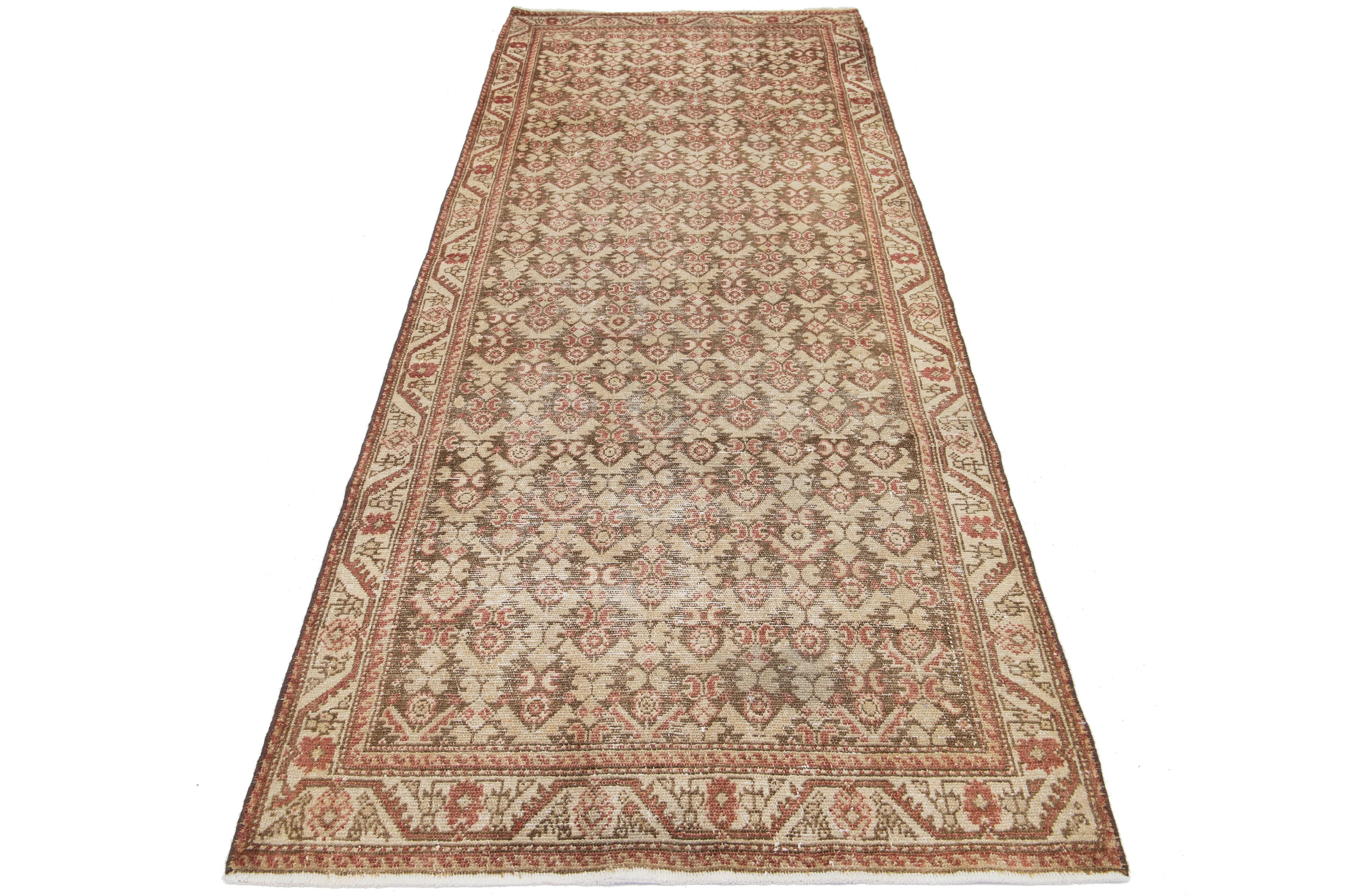 An antique Persian Malayer wool rug with a rust and beige all-over pattern on a brown field.

This rug measures 3'5' x 9'3