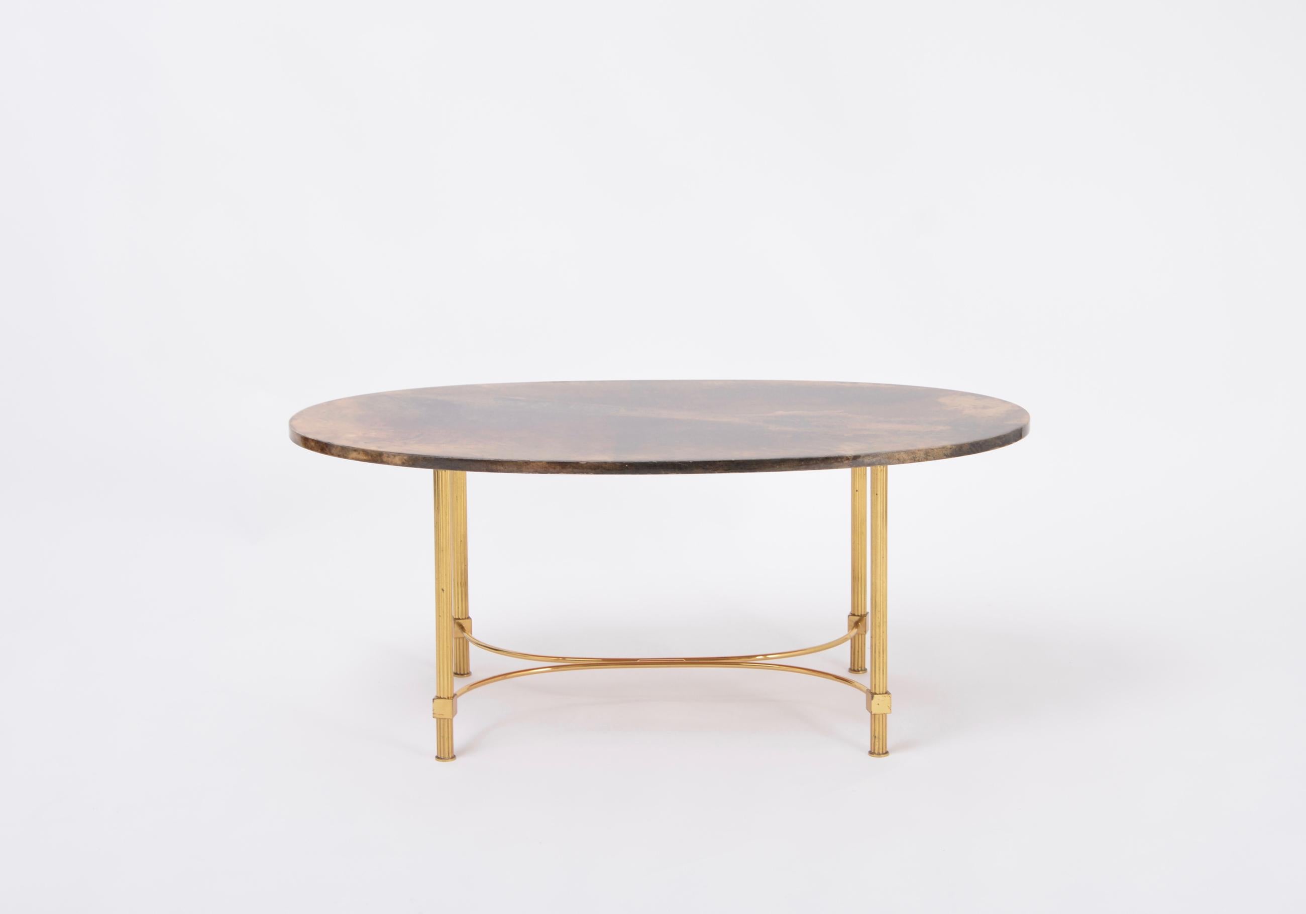 Brown Italian Midcentury Coffee or Side Table by Aldo Tura in Goat Skin
Simple and classical coffee table or side table designed and produced by Aldo Tura (1909-1963).
The oval table top is made of brown parchment, which is sealed with shellac, the
