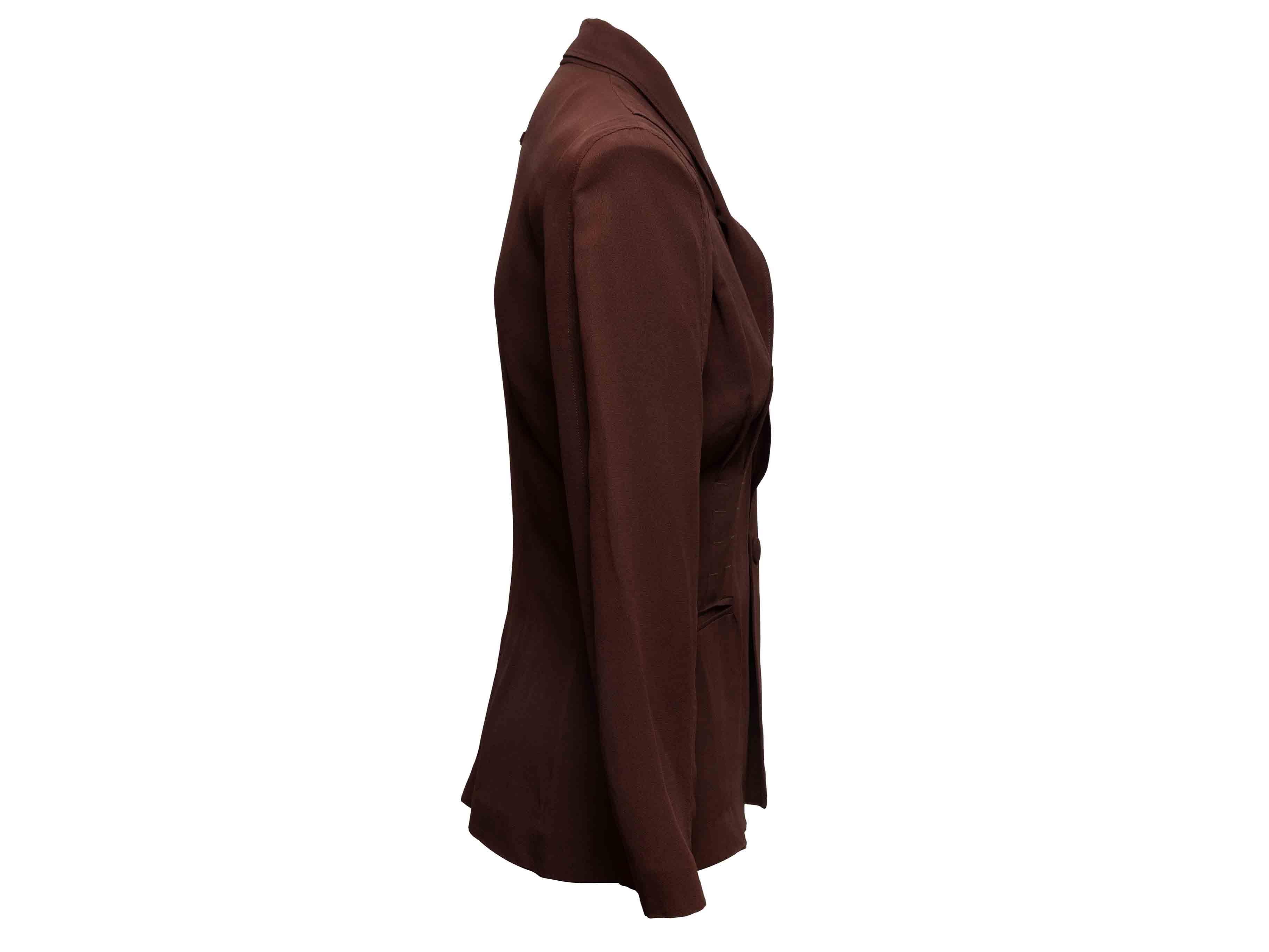 Brown structured blazer by Jean Paul Gaultier Femme. Shawl lapel. Dual welt pockets at hips. Front closure. 34