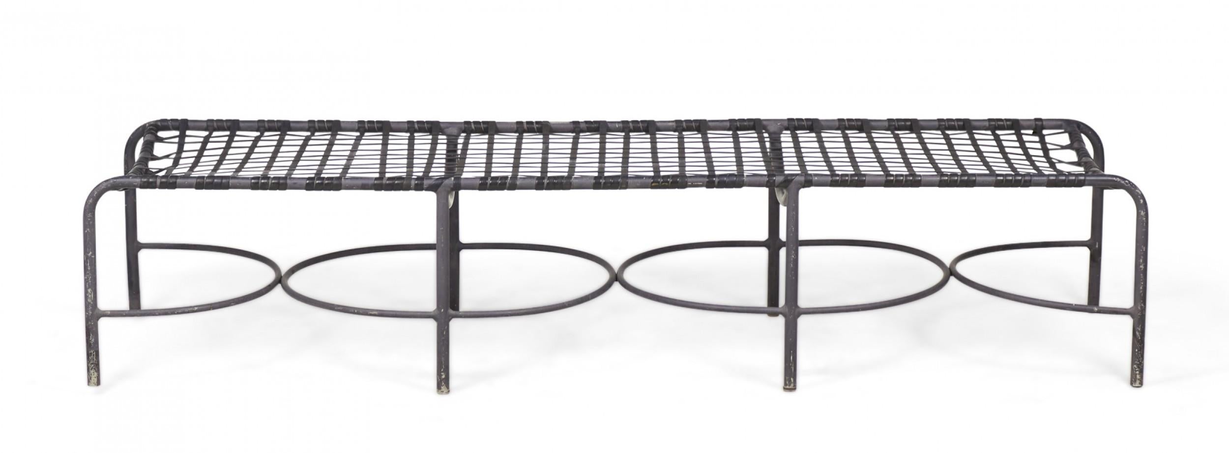 American mid-century outdoor aluminum sun bench / chaise with a latticed aluminum seat resting on eight legs with circular and semicircular stretchers between. (BROWN JORDAN)
