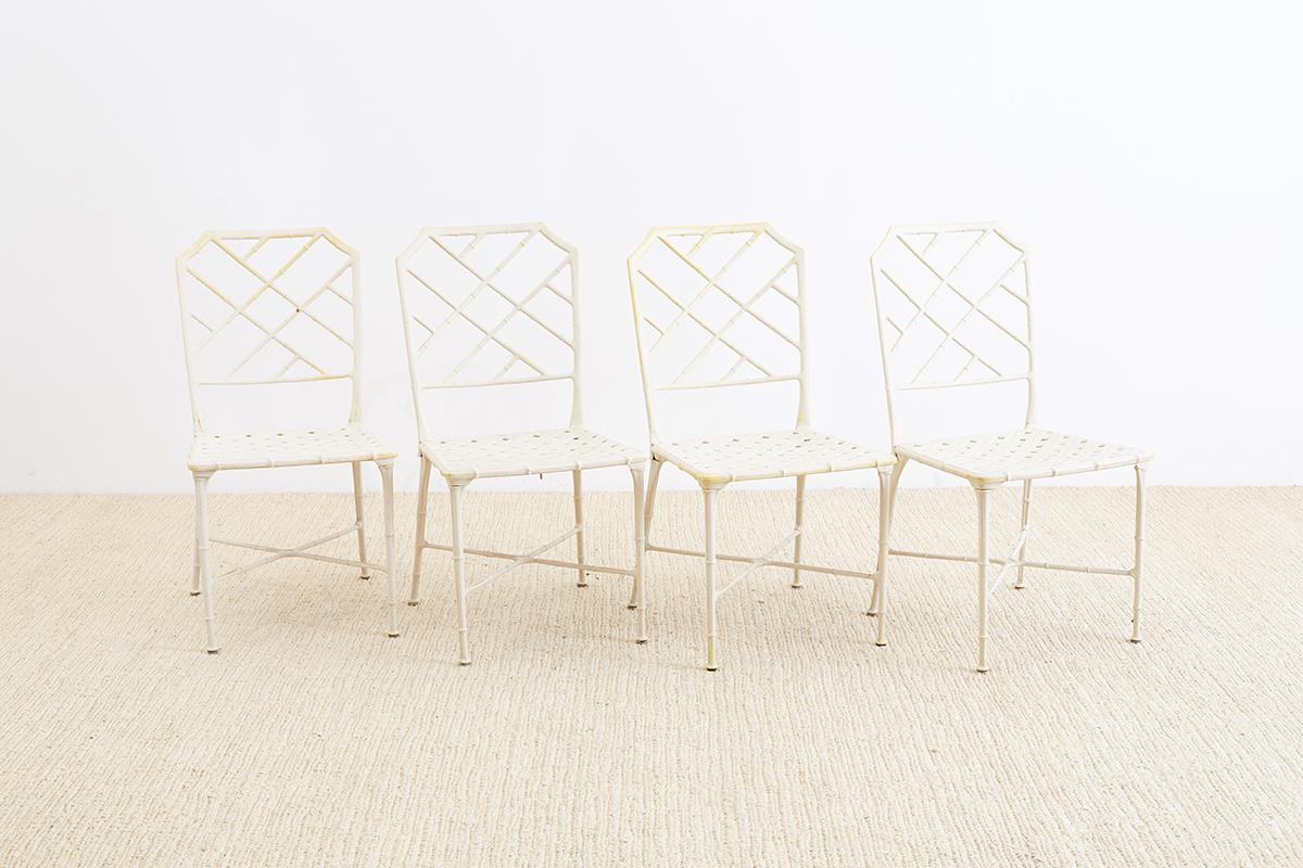 Set of four Palm Beach style brown Jordan Calcutta garden or patio chairs featuring a faux bamboo painted aluminum frame made in a Chinese chippendale style. Each chair has a basket woven design seat and tapered legs with cross stretchers.
