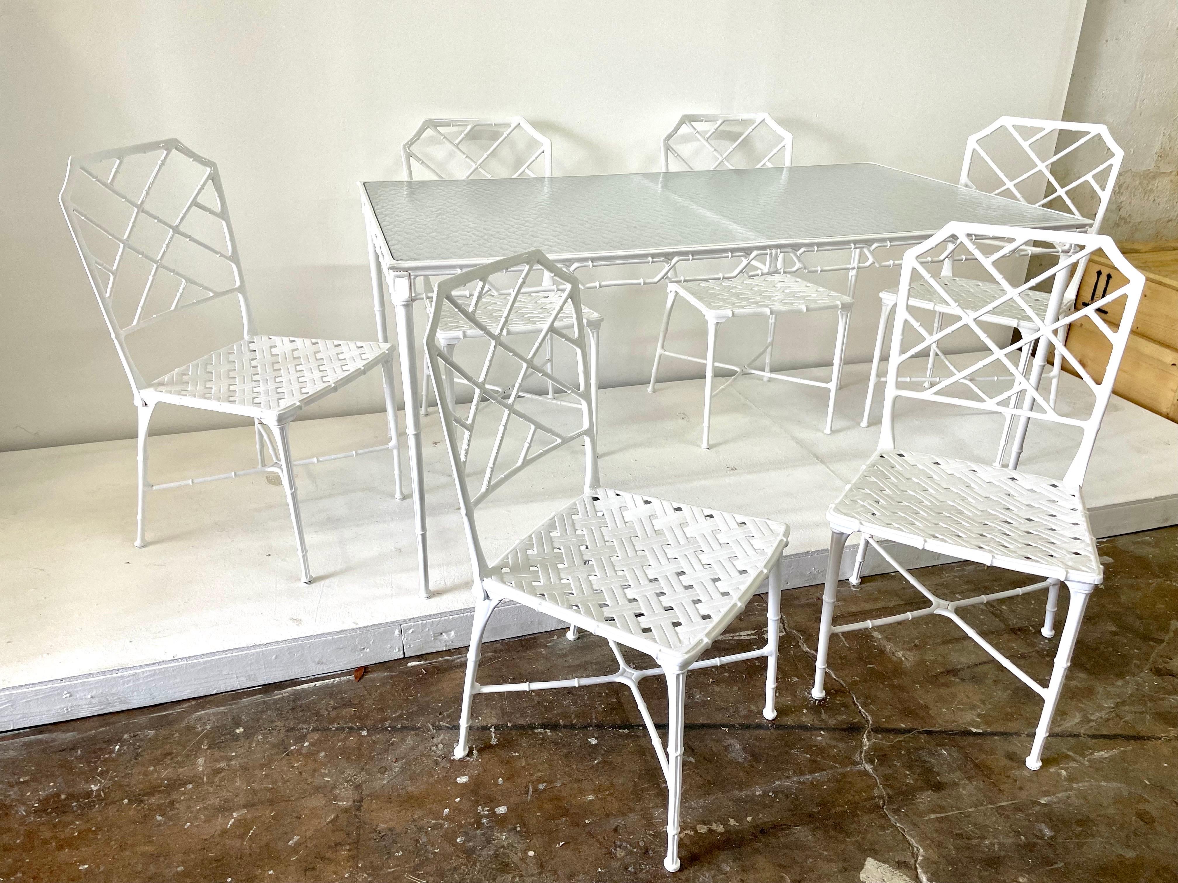 Classic dining set of Chinese Chippendale faux bamboo 6 chairs and table in classic white for outdoor, garden or patio. Recently powder coated white over cast aluminum. Designed by Hall Bradley for Brown Jordan, 1967. Dimensions: CHAIRS Armless =