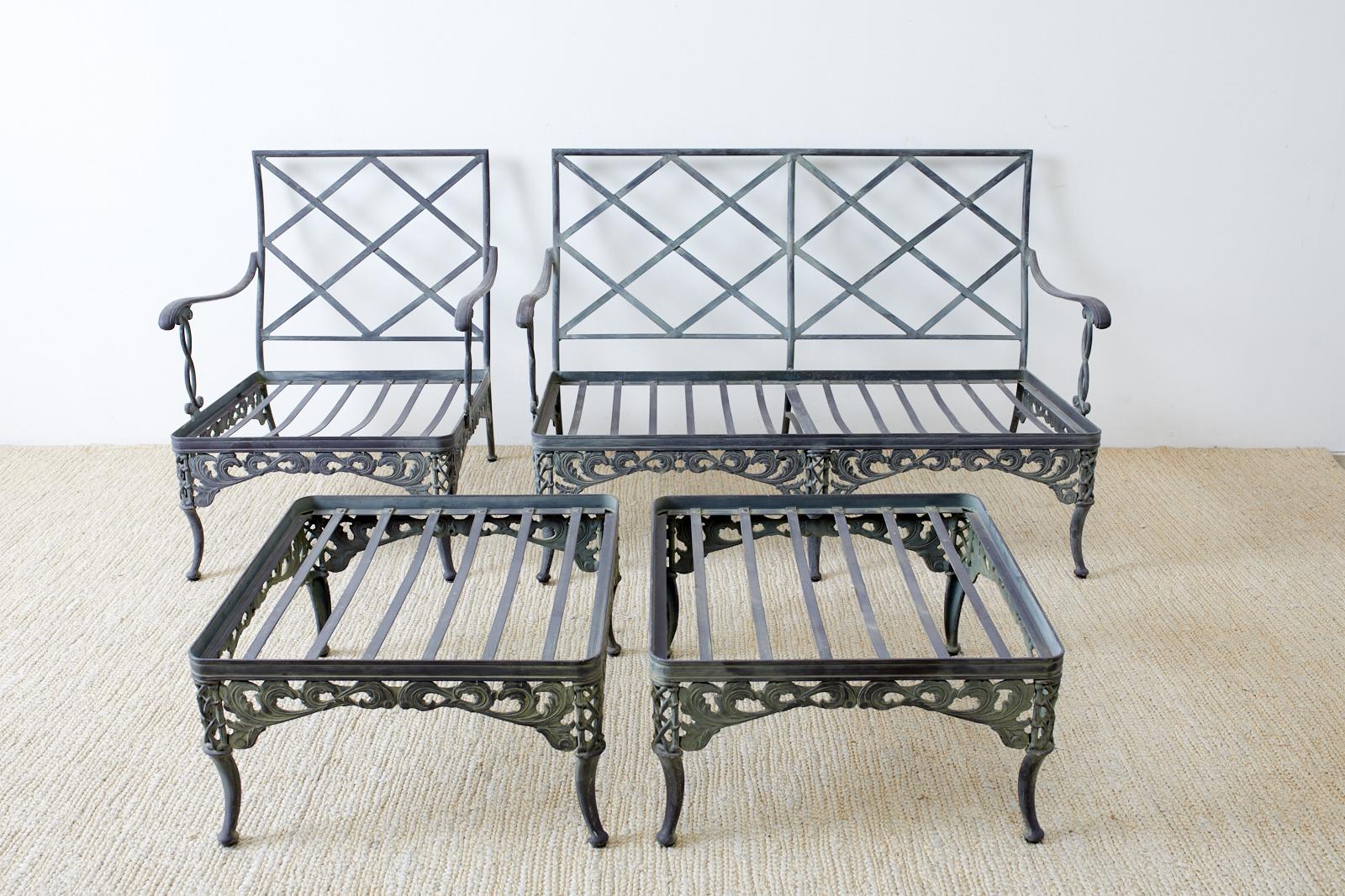 Group of four neoclassical style garden patio set including a settee, lounge chair, and two ottomans. Known as the Florentine design made by Brown Jordan from finely crafted aluminum with a beautifully aged finish and verdigris patina. The settee