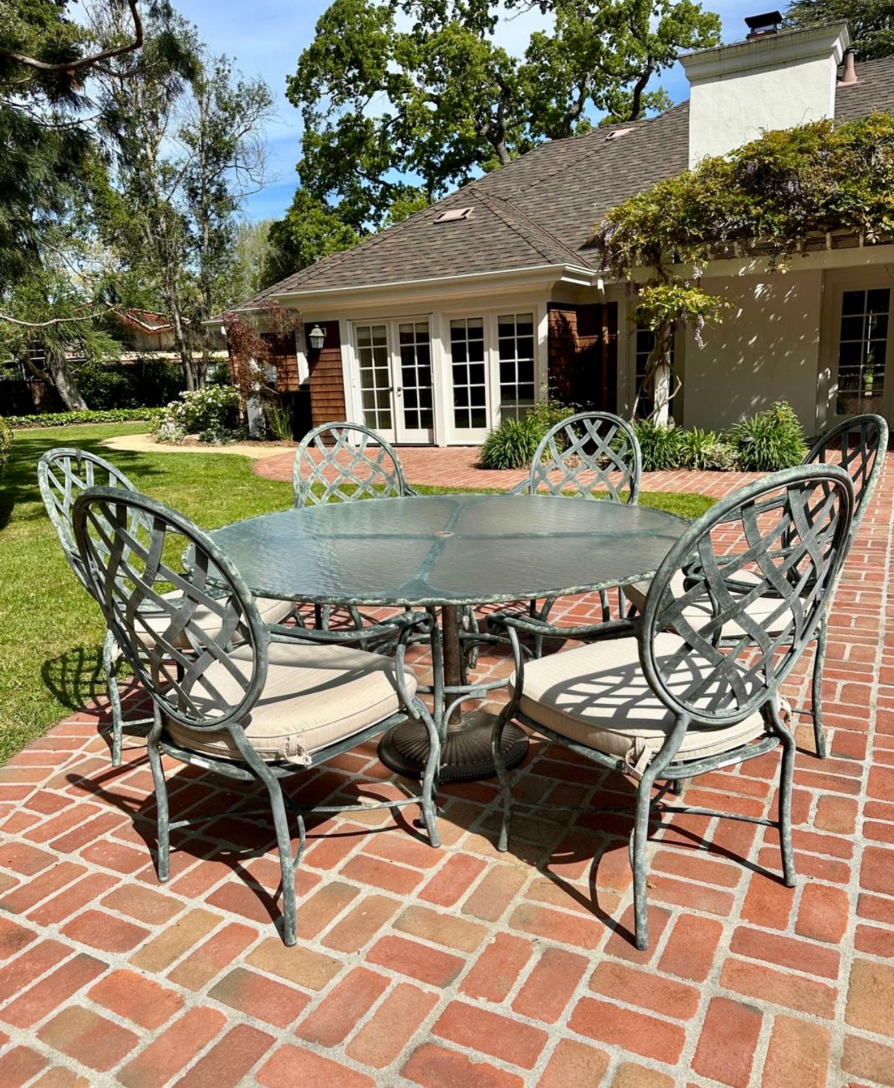 A beautiful outdoor patio furniture by famous manufacturer Brown Jordan
Round glass top table and 6 Armchairs with matching used cushions plus umbrella base
Table measures 60.5 inches in diameter with center umbrella hole and 28” height 

Chair