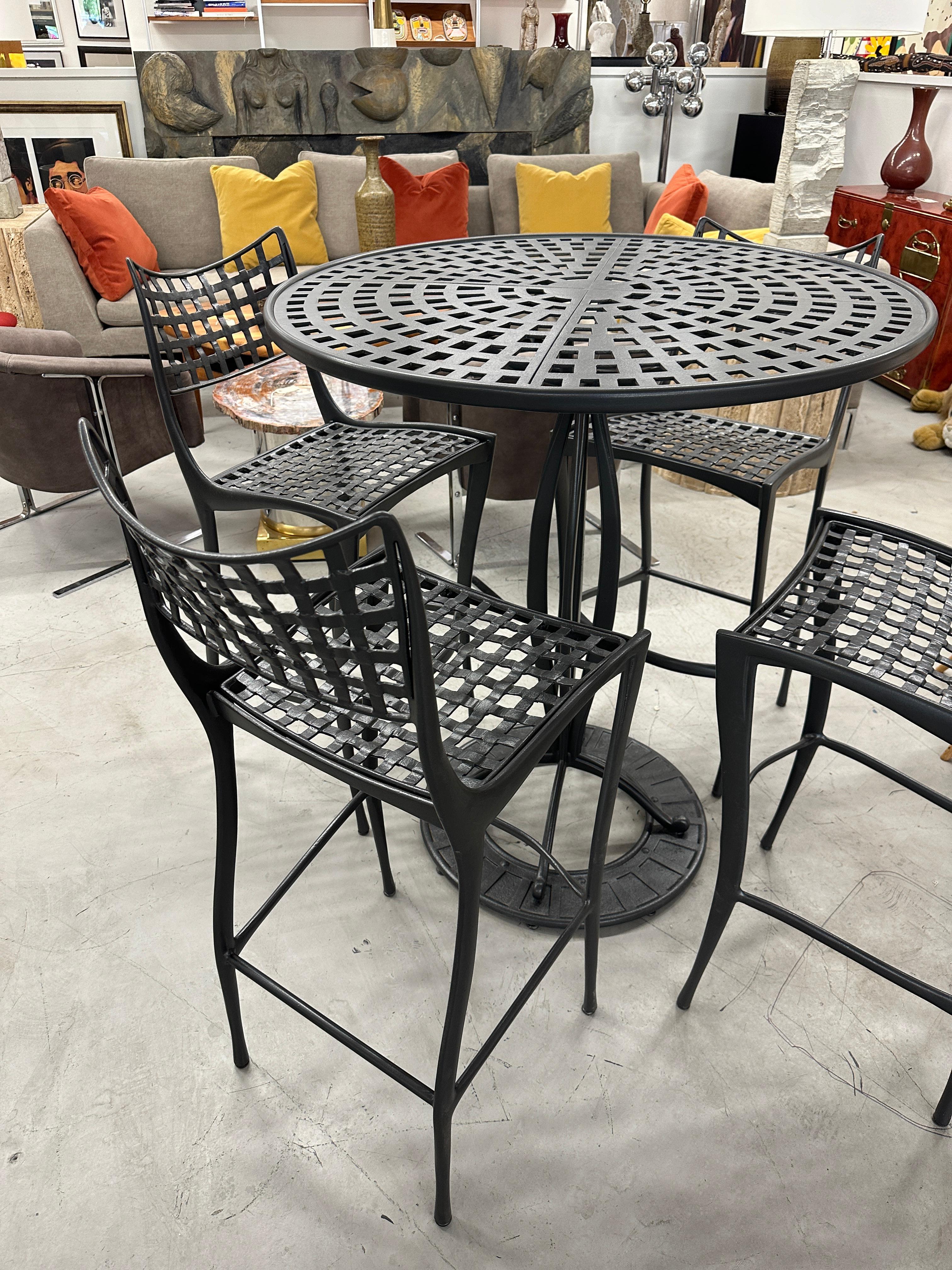 A beautiful set by Brown Jordan. It is a licensed adaptation in Aluminum of Dan Johnson 1950’s Gazelle design. This set has been repowder coated in a bronze color. The table is 37.5 inches in diameter and 42.5 inches tall. The barstools are 42.5