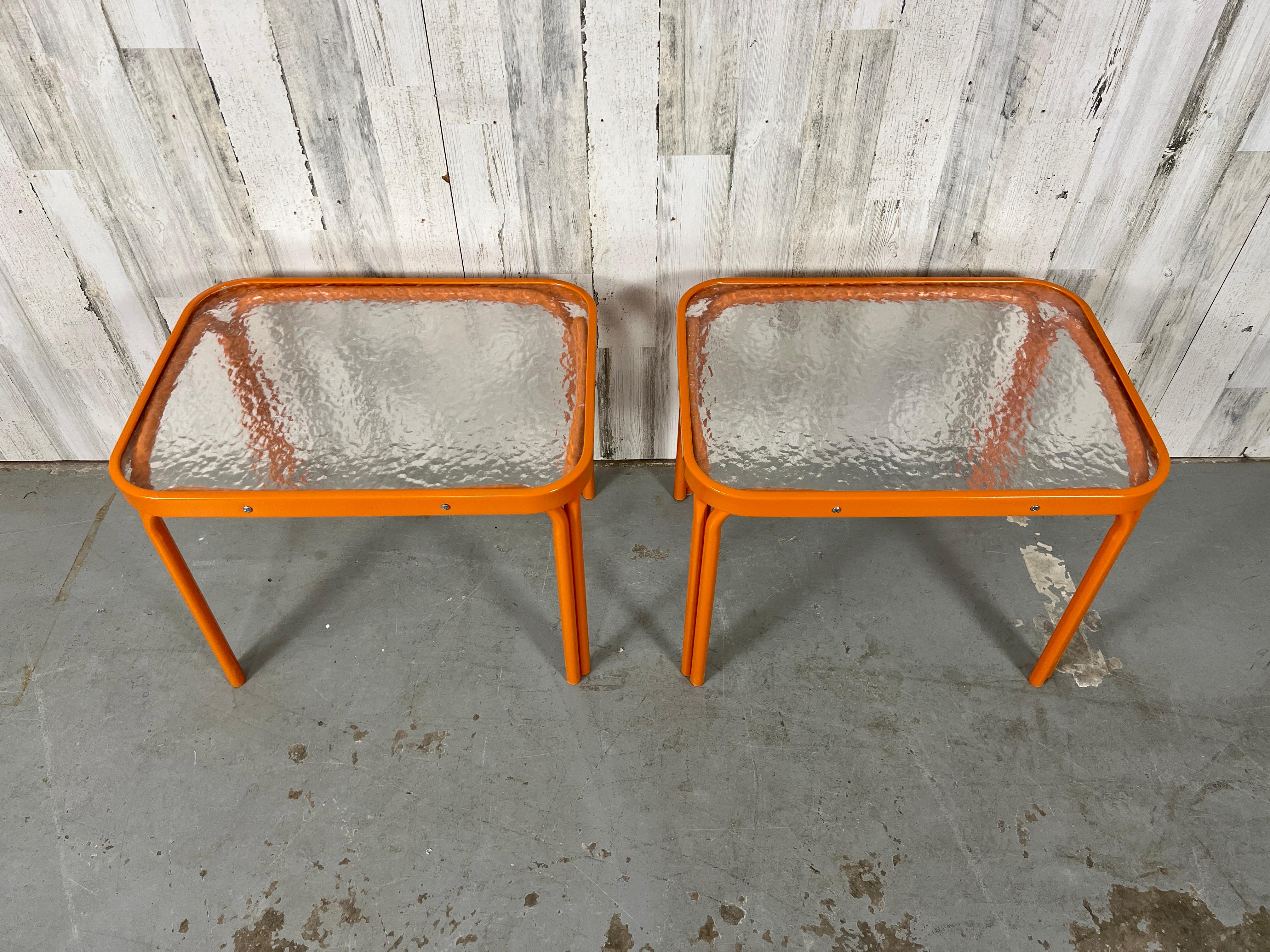 Pair of Tamiami model side tables from Brown Jordan with fresh Citrus orange powder-coating. The original pebble acrylic top does show some wear. 