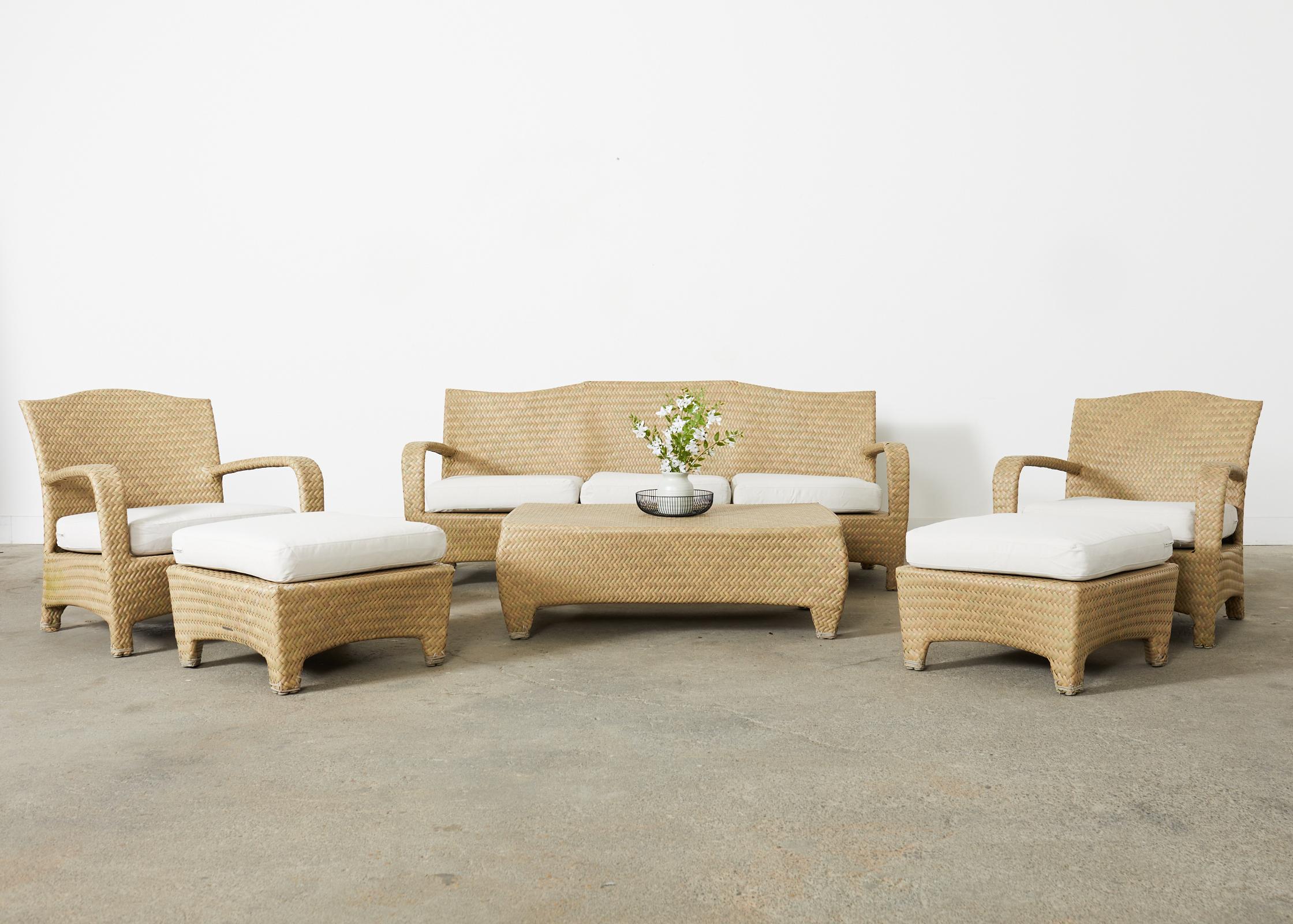 Rare Brown Jordan patio and garden sofa from the Havana collection by Brown Jordan. The sofa features an aluminum frame wrapped with woven resin wicker in stylish earth toned shades. The sofa has a peaked back crest with wide flat arms on each side.